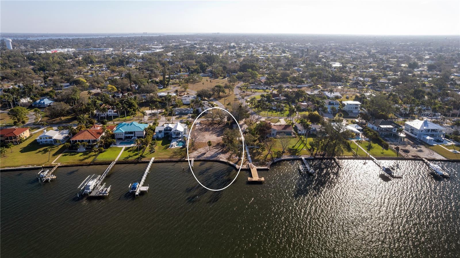 An extraordinary opportunity to own over 26,000 square feet of prime waterfront property in the beautiful coveted Palma Sola, directly on the sparkling waters of Palma Sola Bay. With more than 100 feet of waterfront frontage, this expansive homesite offers breathtaking, unobstructed views of the Bay — delivering unforgettable sunset skies night after night throughout the year.  This oversized lot provides the perfect canvas to build your custom waterfront estate. Design the dream home you've always imagined, with a resort-style pool, expansive outdoor living spaces, and panoramic water views from nearly every room. There’s ample room to create one of the most spectacular backyard retreats on the bay.  Boating enthusiasts will appreciate the ability to build a private dock with lift, keeping your dream boat just steps from your door and offering direct access to open water for sunset cruises, fishing adventures, or Gulf excursions.
Location is everything — and this property delivers. You’re just minutes from the world-renowned beaches of Anna Maria Island, known for their powdery white sand and turquoise waters. Enjoy easy access to the island’s charming shops, waterfront dining, and laid-back coastal lifestyle.
Commuting and travel are effortless with convenient access to Tampa, while also being close to the vibrant energy and exciting growth of downtown Bradenton. From boutique shopping and local restaurants to arts, culture, and entertainment, everything you need is within reach.
Rarely does a waterfront lot of this size, frontage, and prime location become available. Create your legacy property in one of Florida’s most picturesque and well-connected coastal settings.