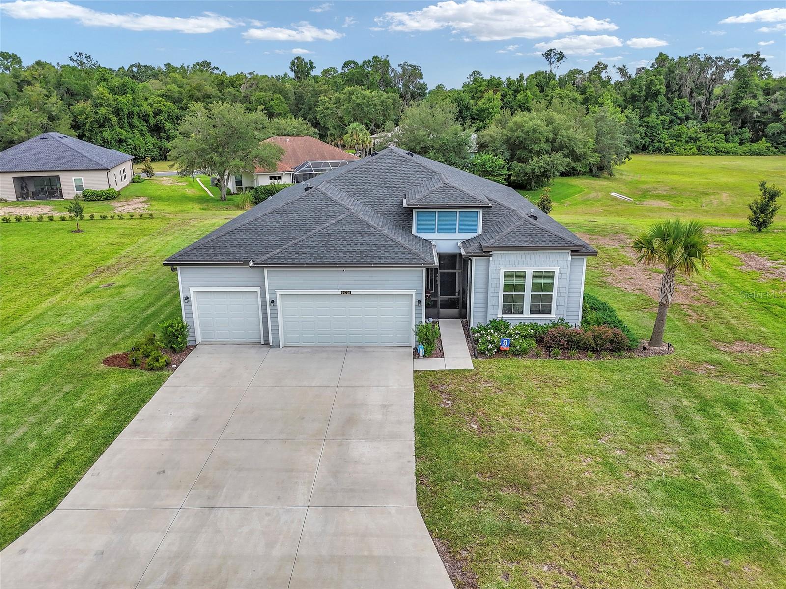 Built in 2024, this immaculate 4-bedroom, 2-bathroom residence offers just under 2,300 square feet of pristine living space, perfectly situated on a generous lot of over a third of an acre. Step inside to discover a bright, open floor plan featuring fantastic wood-look tile plank flooring throughout the main living areas and plush, cozy carpet in the bedrooms. The heart of this home is the show-stopping kitchen, anchored by a massive, conversational island that you truly have to see to believe. Outside, your private oasis awaits with beautiful, serene surroundings. Best of all, this property includes coveted, deeded boat ramp access to the crystal-clear Rainbow River. Practical upgrades abound, including a spacious 3-car garage and a dual-meter water system (separate meters for the home and the irrigation system) to keep your utility bills low and your lawn vibrant. Don't miss this rare opportunity to own a nearly new home with river access!  Outside security camera, patio hanging lights, and mounted televisions do not convey.