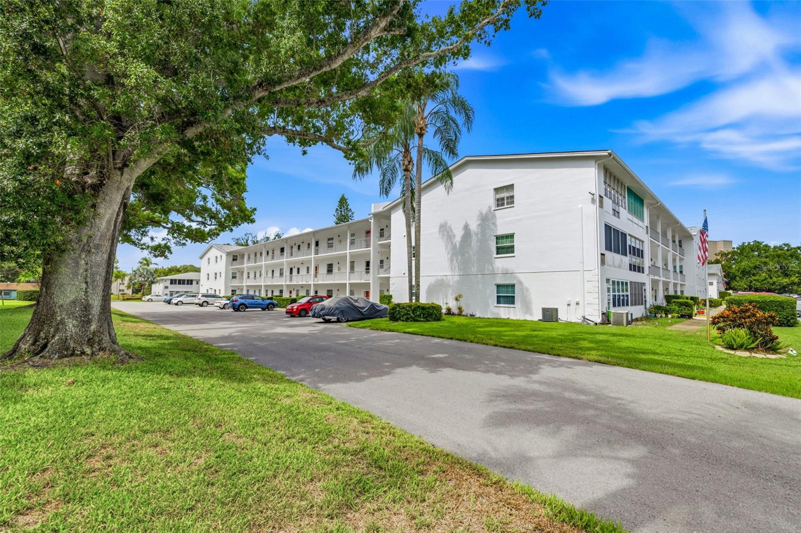 Step into the heart of Dunedin, where the charm of small-town living meets the easy rhythm of coastal life. Nestled within the cherished 55+ community of Douglas Arms, this inviting second floor 2-bedroom condo offers the perfect canvas to create your dream Florida retreat. Inside, this home radiates care and pride of ownership, offering great bones and endless potential for your personal touch. The thoughtful layout features two spacious bedrooms and a full bath, designed for both comfort and functionality. The kitchen is bright and cheerful, complete with ample cabinetry, a front-facing window that fills the space with natural light, and a convenient pass through to the dining and living areas. Just beyond, the fully enclosed Florida room extends your living space bringing the total to over 1,000 square feet. This sunny retreat overlooking green space is perfect for a reading nook or a morning coffee spot and includes a large storage closet for extra convenience. Laundry facilities are conveniently located on-site, and the elevator ensures easy access throughout the building. Life at Douglas Arms is defined by connection and community. Spend your days lounging by the heated pool, joining friends for a friendly shuffleboard match, or gathering in the clubhouse for social events that make every neighbor feel like family. With essentials like cable, internet, water, sewer, trash, pest control, building insurance, and grounds maintenance all included in the monthly fee, you can truly embrace a low-maintenance lifestyle. One assigned parking space adds convenience, and the no-pet, no-rental policy ensures a quiet, peaceful setting for those seeking tranquility. Just a short stroll from the lively downtown village, you’ll find yourself surrounded by local festivals, unique boutiques, cozy cafes, and beloved breweries, all part of Dunedin’s warm and welcoming spirit. Sports lovers will appreciate being near the Toronto Blue Jays spring training stadium, while nature enthusiasts can explore the scenic Pinellas Trail or soak up the sun on Honeymoon and Caladesi Islands. Bring your imagination and your own style to this well-maintained home and reimagine it in beautiful Dunedin. Schedule your showing today and discover the relaxed Florida lifestyle waiting for you.