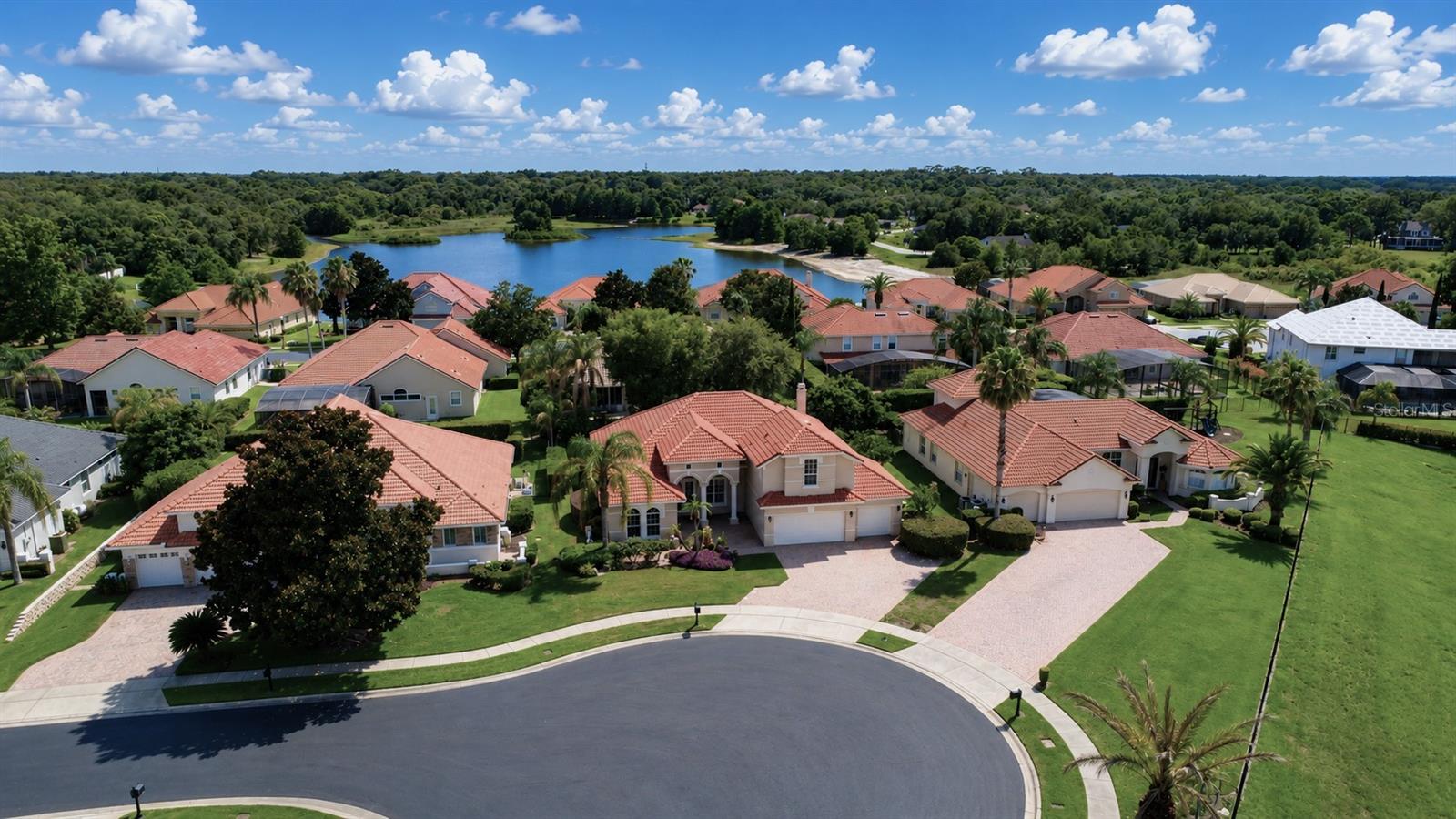 Welcome to this exceptional residence in the prestigious gated community of Hidden Cove, where timeless elegance, modern luxury, and exceptional craftsmanship combine to create an extraordinary place to call home. Perfectly situated on a beautifully landscaped 0.26-acre homesite, this meticulously maintained home offers 3,009 square feet of thoughtfully designed living space featuring four bedrooms, four full bathrooms, a dedicated home theater, an expansive bonus room, and spectacular resort-style outdoor living. Built in 2000 and extensively updated, the home showcases quality finishes and an impressive list of improvements, including double-pane windows, extensive crown molding, whole-home automation, a comprehensive security system, fresh interior and exterior paint, replacement of all HVAC systems, two 80-gallon water heaters, complete house replumbing, spray-foam insulation above the garage, and numerous additional enhancements that provide exceptional peace of mind. The luxurious first-floor owner's suite serves as a private retreat with a beautifully renovated spa-inspired bathroom, while the professionally designed home theater delivers an unforgettable cinematic experience featuring tiered reclining theater seating, a Sony 4K projector, premium receiver, custom lighting, and automated blackout shades, all controlled effortlessly at the touch of a button. Designed for both everyday living and elegant entertaining, the gourmet chef's kitchen features a large center island, breakfast bar, cooktop, built-in ovens, stainless steel appliances, an oversized pantry, and abundant preparation space while opening seamlessly to the spacious family room highlighted by a custom-built entertainment center and dramatic corner sliding glass doors that fully retract to create a true indoor-outdoor living experience. Step outside to your private backyard retreat where the expansive screened lanai showcases a sparkling heated pool, heated whirlpool spa, fully equipped summer kitchen, generous covered entertaining areas, and multiple spaces for relaxing or hosting family and friends in complete privacy. Upstairs, the oversized bonus room with a full bathroom offers incredible flexibility as a guest suite, game room, media room, fitness studio, executive office, or additional living space. Electric vehicle owners will appreciate the integrated high-speed Bluetooth-enabled smart charging station, while the insulated, air-conditioned attic and additional storage areas provide approximately 400 square feet of climate-controlled space beyond the listed living area—a rare and valuable feature. Ideally located near major highways, premier shopping, fine dining, and Seminole County's highly rated schools, this exceptional Hidden Cove residence offers the perfect blend of luxury, privacy, convenience, and resort-style living, presenting a rare opportunity to own one of the community's most impressive homes.