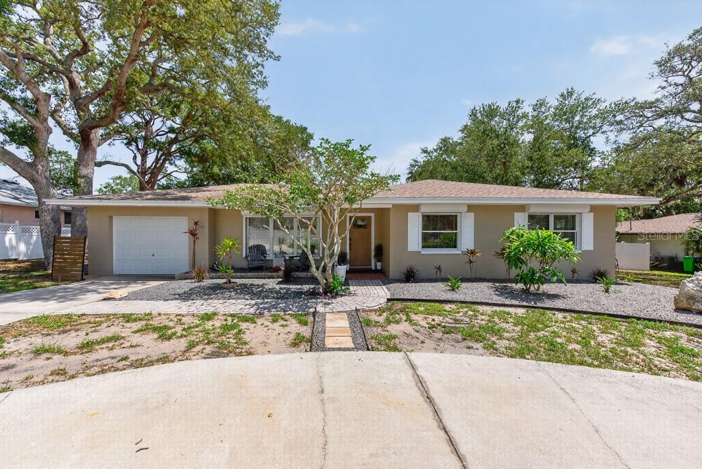 BUYER FINANCING FELL THROUGH! Just 1.5 miles from Indian Rocks Beach, this move-in-ready pool home sits on a rare .38-acre double lot in unincorporated Pinellas County, offering the freedom of no HOA, no CDD fees, and short-term rental potential. Located in an X flood zone, no flood insurance is required. The home offers 1,494 square feet of comfortable living space with 3 bedrooms, 2 bathrooms, a one-car garage, and a wraparound driveway that provides ample parking. Excellent curb appeal, mature landscaping, and hurricane shutters—including electric shutters on several windows—add both charm and peace of mind. Inside, durable vinyl plank flooring flows throughout much of the home. The spacious family room creates an inviting gathering space, while the kitchen features wood cabinetry, granite countertops, stainless steel appliances, and a bright eat-in dining area. Adjacent to the kitchen, the Florida room is lined with wall-to-wall windows, filling the space with natural light and offering beautiful views of the backyard. A versatile office or bonus room overlooks the pool and backyard through oversized windows, making it ideal for a home office, fitness room, playroom, or additional living space. The primary suite features vinyl plank flooring, a stylish chandelier, and tranquil views of the outdoor living area. The en-suite bath includes a walk-in tiled shower and vanity. Two additional bedrooms also feature vinyl plank flooring and modern chandeliers, while the guest bathroom offers a quartz vanity and a shower/tub combination. Designed for enjoying the Florida lifestyle, the backyard is a private retreat complete with a paver patio and pool deck, saltwater pool, hot tub, and lush mature landscaping. Recent pool updates include a new heater/chiller in 2024 and a new salt cell in 2025. The fully fenced yard includes a gate providing access for boat or RV storage—an increasingly rare feature this close to the Gulf beaches. The one-car garage includes a dedicated laundry area and additional storage space. Conveniently located near shopping, dining, entertainment, and some of Pinellas County's most beautiful beaches, this property offers exceptional flexibility as a primary residence, vacation getaway, or income-producing investment. Large lots, private pools, no deed restrictions, and proximity to the beach make opportunities like this increasingly hard to find. ***FREE 1/0 Rate Buydown when using the seller's preferred lender!***