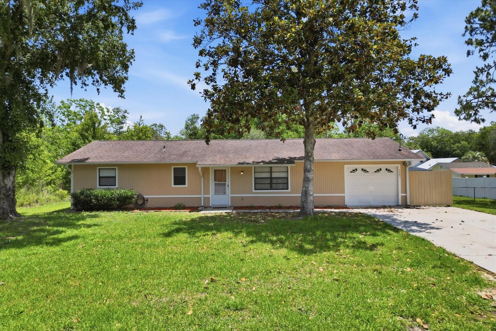 One or more photo(s) has been virtually staged. Discover comfortable Florida living in this 2-bedroom, 2-bathroom single-family home situated on a 0.51-acre lot in Sasser Oaks. The home features a 16x12 screened porch and a fully fenced backyard, offering ample space for outdoor enjoyment. Additional highlights include a 1-car garage. Conveniently located east of US-19, this property provides a peaceful setting while remaining close to local shopping, dining, and the Homosassa River area. No HOA. Schedule your showing today.