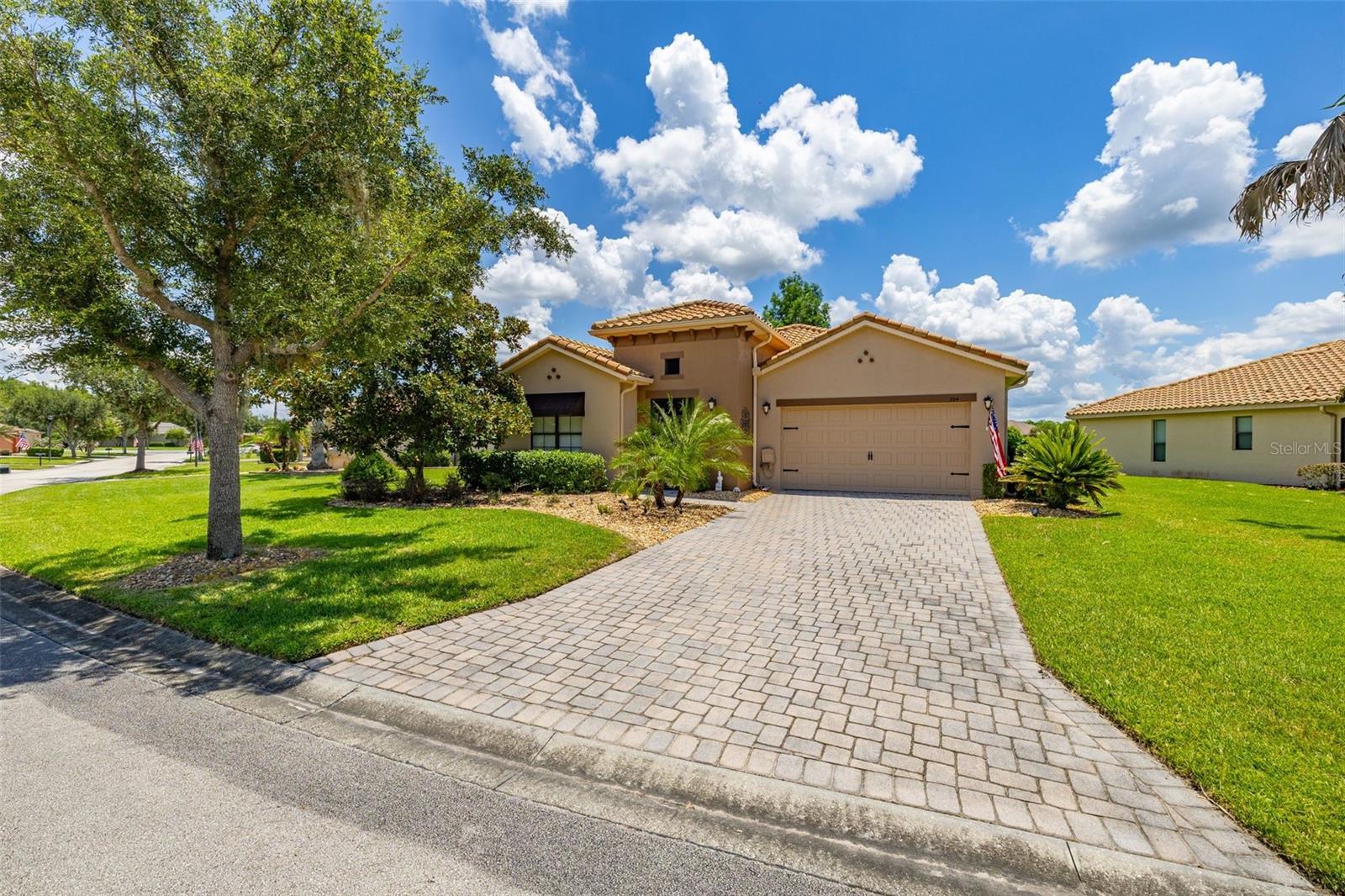 RARE LAKESIDE PARADISE! Experience exceptional active 55 plus community in this move-in-ready lakeside home, where striking curb appeal meets a thoughtfully designed layout. From the moment you enter, the property welcomes you with an immediate sense of warmth and an impressive view of the water. To the left of the foyer, a privately situated second bedroom and full bathroom an ideal layout for guests. Further down the hall, a convenient half-bath is positioned perfectly near the dedicated laundry room for seamless everyday functionality. The heart of the home opens up into a large, spacious kitchen and dining area designed for both casual meals and effortless entertaining. This culinary space features premium quartz countertops, modern stainless steel appliances, recessed lighting, and elegant 42-inch upper cabinets enhanced by under-cabinet lighting. From the kitchen, you face directly out to the water. You can enjoy these stunning lakeside vistas year-round from the enclosed lanai, which features its own dedicated mini-split A/C system for independent climate control, or enter the adjacent screened-in patio, which comes complete with the patio furniture and BBQ grill included. The primary owner's suite serves as a true private retreat, offering two expansive walk-in closets and a versatile alcove perfect for a computer desk or cozy reading nook. The attached en-suite bathroom is beautifully appointed with separate dual vanities divided by a custom makeup station, alongside a pristine tiled shower equipped with a glass door, safety grab bars, and a spacious 8x8 sitting bench. Complete with a durable tile roof and a two-car garage featuring a dedicated golf cart outlet, this property delivers the ultimate Florida retirement lifestyle.  Located inside the premier, 55-plus guard-gated development of Solivita, this property offers an unparalleled lifestyle across 4,300 acres of scenic waterways and green spaces and wildlife. Residents enjoy a high-end club environment anchored by over 150,000 square feet of dedicated recreational facilities. Golf enthusiasts can take advantage of the Stonegate Golf Club, featuring two championship 18-hole courses and an aquatic driving range. The community features 14 heated swimming pools—including indoor and outdoor lap options and hot tubs—alongside the massive Riviera Spa and Fitness Center, complete with an air-conditioned indoor walking track. For outdoor sports, the expansive layout incorporates 17 pickleball courts, over a dozen tennis courts, bocce ball, shuffleboard, and a full softball field. At the vibrant village center, enjoy three on-site restaurants, a full-service spa, a pharmacy, and creative studios for arts, billiards, and ceramics with kilns. A 17,000-square-foot ballroom hosts regular live entertainment, coordinating with a calendar of over 150 active social clubs. Make this dream home become your reality, call me for a showing today!