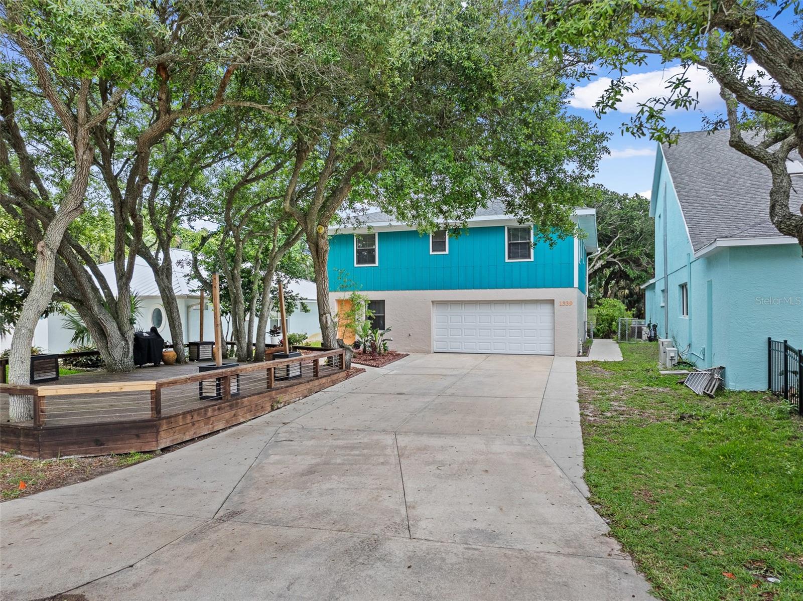 Coastal Living at its Finest in Flagler Beach! Nestled beneath a stunning canopy of mature coastal oak trees, this immaculate home boasts a massive front deck perfect for enjoying the ocean breezes. Perfectly positioned just 2 blocks from the ocean in the highly desirable Flood Zone X, this property offers the ultimate beachside lifestyle alongside excellent peace of mind, featuring a new roof installed in 2023 and a dual A/C system (units updated in 2023 and 2015). Step inside to a light filled interior featuring fresh professional paint, beautiful flooring, and high-end modern finishes throughout. The chef’s kitchen is an absolute showstopper, boasting sleek cabinetry, premium stainless steel appliances, a massive center island, and an open dining space. The luxurious bathrooms are beautifully updated with contemporary vanities, elegant gold hardware, and custom tile work. Enjoy outdoor living on your multiple decks or retreat to the private, backyard oasis complete with a fire pit. Best of all, you are just a short walk to local parks, coastal boutiques, dining, and the iconic Flagler Beach Pier. Move right in and start living the dream!