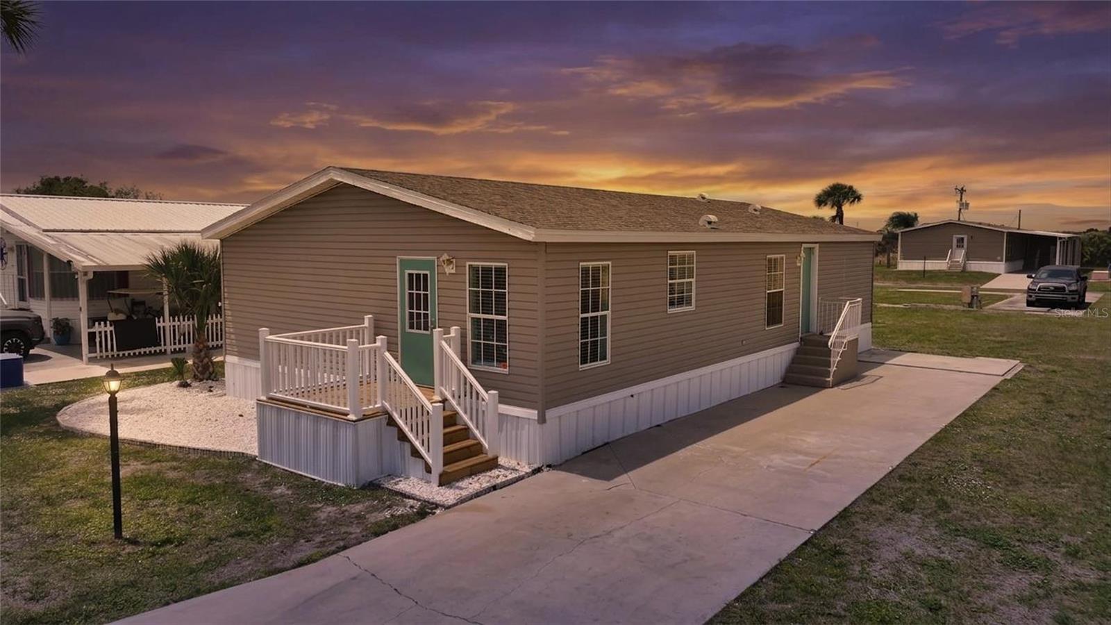 Welcome to easy, relaxed living in this well-maintained 3-bedroom, 2-bathroom doublewide home located in the sought-after 55+ community of Desoto Village. Built in 2006 and offering approximately 1,200 square feet of thoughtfully designed space, this home blends comfort, convenience, and peace of mind—now featuring a new 2024 roof with a transferable warranty.

Inside, you’ll find a spacious living area filled with natural light, a bright and functional kitchen, and a private primary suite complete with its own full bath. Two additional bedrooms provide flexible space for guests, hobbies, or a home office, while the indoor laundry area adds everyday ease.

A brand-new carport and storage shed are currently being constructed and will be completed prior to closing, adding even more value and practicality to the property.

Desoto Village is a pet-friendly, age-restricted community designed with active adults in mind. Residents enjoy a variety of amenities including a fitness center, sparkling pool, clubhouse, library, recreation room, and extra storage. The peaceful fishing lake offers the perfect spot to unwind and enjoy Florida’s natural beauty.

Ideally situated, you’re just a short drive from Port Charlotte and Punta Gorda, where you’ll find shopping, dining, and waterfront attractions. For beach lovers, the world-renowned shores of Siesta Key are approximately 45 minutes away, making day trips to the Gulf a breeze.

You’ll also appreciate the nearby charm of Arcadia, known for its historic downtown, antique shops, local dining, farmers markets, and vibrant community events that capture the essence of Old Florida living.

Conveniently located near major roadways such as Highway 70 and Interstate 75, this home offers easy access while maintaining a quiet, community-centered lifestyle.

This is an excellent opportunity for those 55 and better seeking a low-maintenance home in a welcoming, amenity-rich community with everything you need close by.