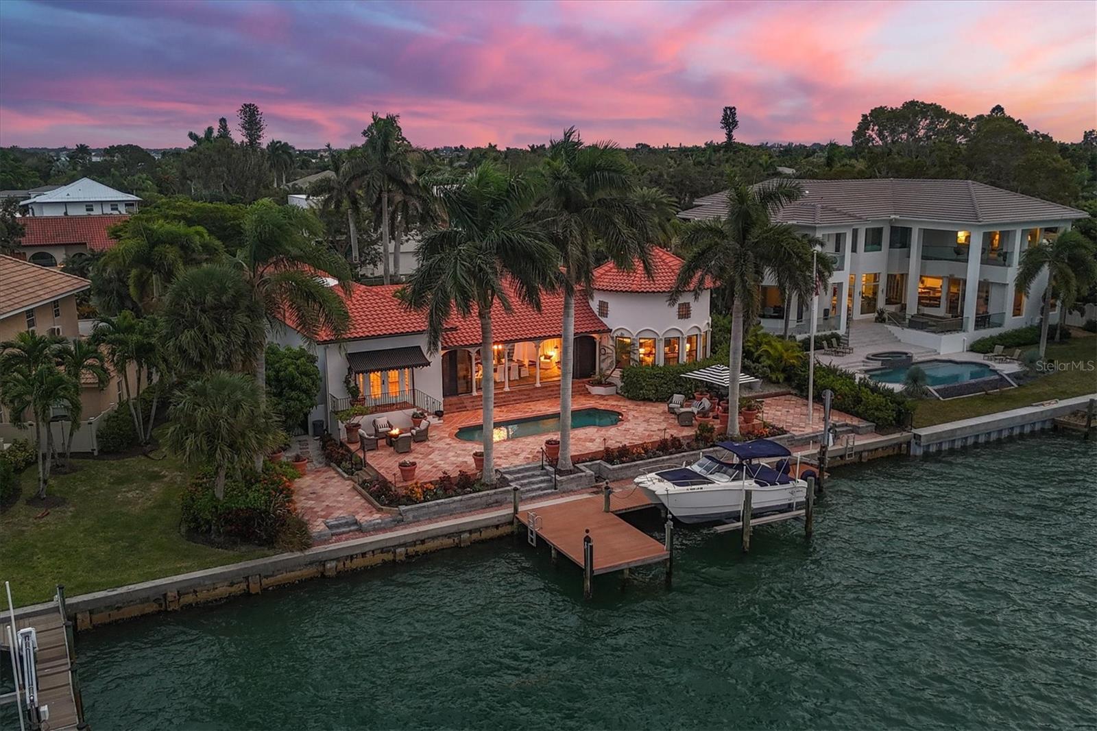 Welcome to your dream residence on coveted Bird Key! This exquisite Spanish Mediterranean-style courtyard home offers an unparalleled blend of luxury, comfort, and breathtaking views. Boasting 3 bedrooms and 4 baths, this meticulously designed bayfront property provides an oasis of tranquility in the heart of Sarasota and direct access via your private deep-water dock to the Gulf of Mexico. As you enter through the gated courtyard, you are greeted by the allure of a trickling fountain, surrounded by lush landscaping, creating a serene and secluded retreat. The courtyard design seamlessly integrates indoor and outdoor living spaces, perfect for entertaining or enjoying quiet moments of relaxation. The interior of this home exudes elegance, with a spacious floor plan bathed in natural light. The living areas showcase impeccable attention to detail, featuring high ceilings, arched doorways, and beautiful tile flooring that complements the Spanish Mediterranean aesthetic. The gourmet kitchen is a culinary enthusiast's delight, equipped with top-of-the-line appliances, including a Subzero fridge, 6 burners w/ griddle Wolf range & double ovens, multiple beverage coolers and a large, Carrara marble island boasting an additional sink. Whether you're preparing a casual meal or hosting a grand dinner party, this kitchen is both functional and stylish, with custom cabinetry, reclaimed barn wood flooring and premium finishes. The three bedrooms offer comfort and privacy, each with its own en-suite bath. The master suite is a sanctuary of luxury, complete with spa-like amenities, a soaking tub, 2 walk- in closets and private access to the backyard retreat. Bird Key is renowned for its exclusive waterfront lifestyle, and this residence epitomizes the best it has to offer. From the private pool oasis to the sweeping views of downtown Sarasota and the Ringling Bridge, every detail of this property reflects a commitment to a life of sophistication and leisure.