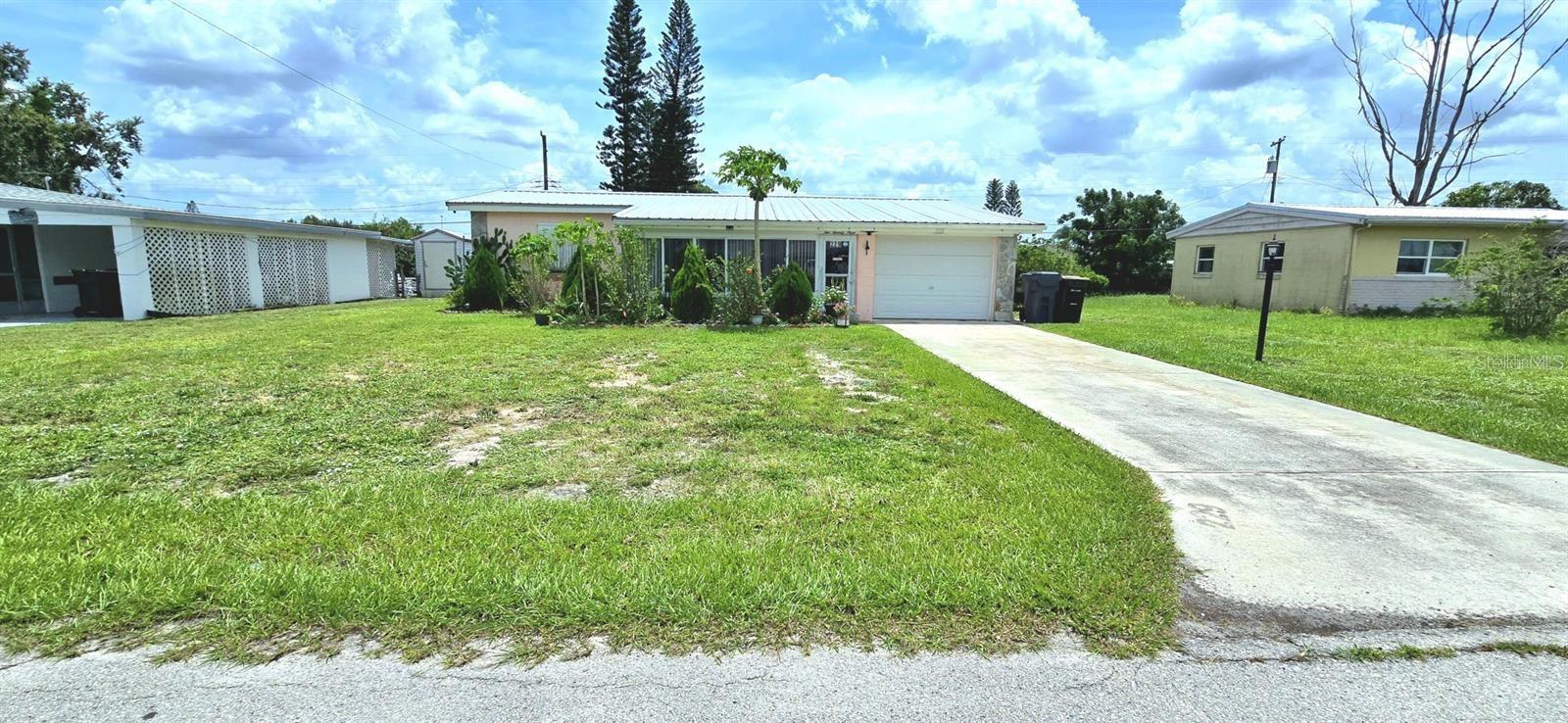 Single family home on 0.21 acre lot. This charming 3 bedrooms, 2 bath home sits on a spacious fully fenced lot filled with lush tropical landscaping and a wide variety of mature fruit trees including mango, guava, lemon, banana, grapes, cherry, and more. Enjoy Florida living with a large gazebo, colorful front flower garden, and a dedicated area for growing vegetables. Inside the home features modern tile flooring, updated kitchen fixtures, new toilets & showers in bathrooms, and ceiling fans throughout. Major updates include newer a/c units (less than 3 yrs old), updated plumbing, newer septic system, and built-in shelving in garage. Bonus features include a separate storage casita and a 24/7 security camera system. Peaceful, private, and move-in ready; this home is a perfect blend of comfort and nature.