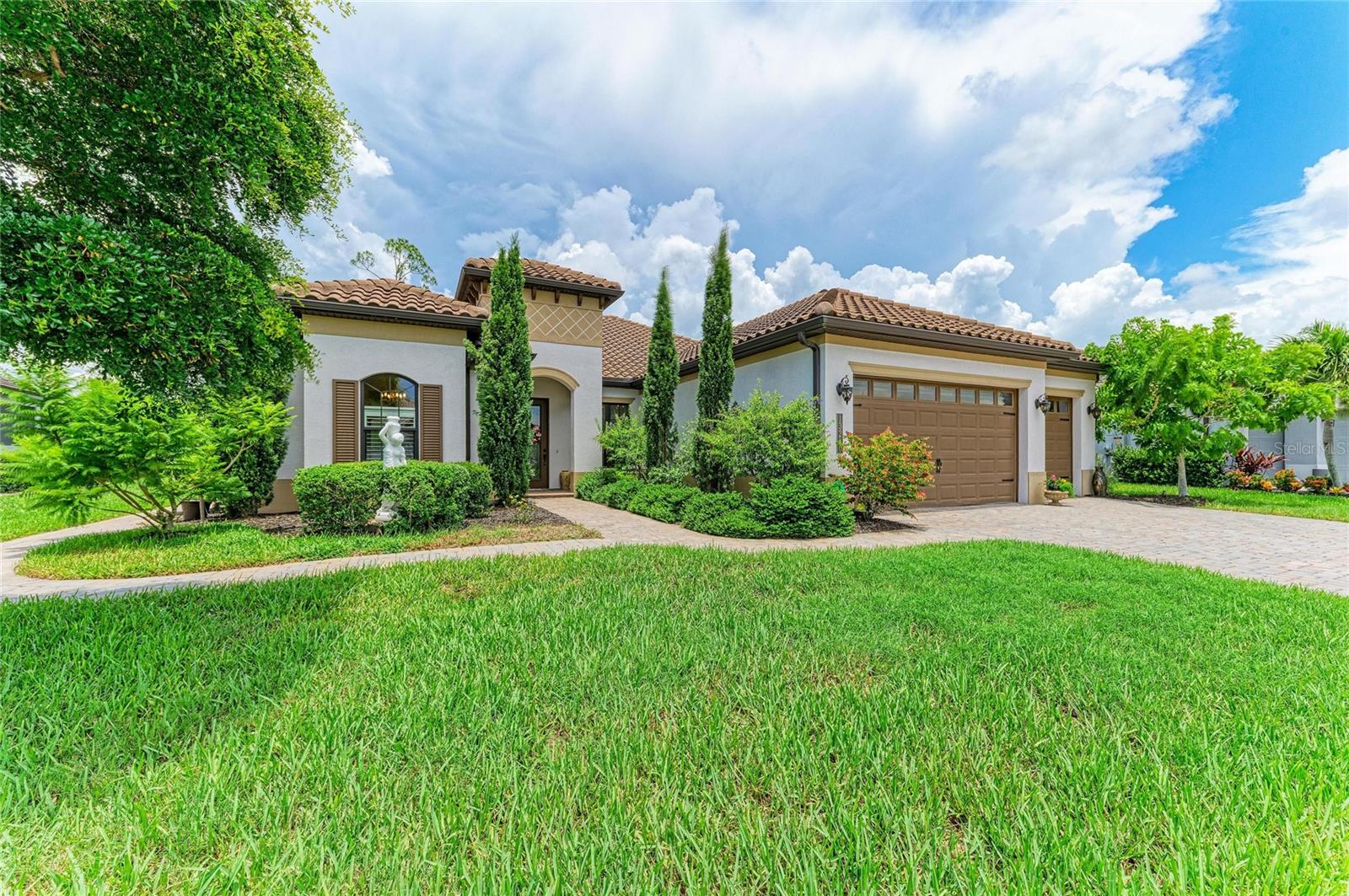 This CUSTOM LUXURY HOME is listed for BELOW RECENT APPRAISED VALUE! Located in the sought-after Tuscan-inspired resort-style community of Gran Paradiso. This Sam Rogers home features 3 bedrooms, 3 baths, an OVERSIZED 3-car garage (with whole-home 12.24 TESLA SOLAR POWER) with 3 backup power walls) 2 offices, a sunroom, a sitting room, and a bonus room. The OPEN FLOOR PLAN is designed for comfort, elegance, and natural light. The inside abounds with VAULTED and TRAY CEILINGS in most rooms, LUXURY VINYL PLANK FLOORING throughout, HURRICANE IMPACT FLOOR-TO-CEILING WINDOWS and DOORS, ARCHED DOORWAYS, TRANSOM WINDOWS, CROWN MOLDING, ELEGANT LIGHTING and DESIGNER WALLPAPER. The great room features CUSTOM FAUX PAINTED BEAMS, an OLD WORLD BRICK FEATURE WALL, and a CRYSTAL CHANDELIER. Natural lighting flows from the SUNROOM that overlooks the 3-TIERED FOUNTAIN on the BACK YARD TERRACE, designed with two sliding windows that open from the bottom to top to let in the FLORIDA BREEZE. Three CRYSTAL PENDANT LIGHTS invite you to the CHEF'S KITCHEN, complete with QUARTZ COUNTERTOPS, 42-inch soft-close WOOD CABINETS, with glass display cabinets, BACKSPLASH, under-cabinet lighting, a COOKTOP with an overhead vented-out exhaust. Reverse osmosis feeds the refrigerator and the water for the granite composite sink. The OVERSIZED WALK-IN PANTRY is complete with custom wood shelving. The dining room boasts a ONE OF A KIND TUSCAN MURAL that was painted by a local artisan. The sprawling primary bedroom feels like HEAVEN, complete with TRAY CEILINGS and a BRIGHT SITTING ROOM that overlooks the backyard Terrace. The Marble-inspired master bathroom boasts DUAL VANITIES, a BUILT-IN MAKEUP VANITY, a WALK-IN SHOWER with a frameless shower glass door, shampoo niche, and shower seat. Stroll into the primary suite closet featuring a MARBLE TOP ISLAND and a CUSTOM CLOSET ORGANIZATION SYSTEM. His and Hers offices will provide quiet and private workspaces. FRENCH DOORS lead to the office adjacent to the front entry. The second office provides convenient access to the outside terrace. Two guest bathrooms are near or en-suite to the guest bedrooms, decorated with DESIGNER WALLPAPER, QUARTZ COUNTERTOPS, and FRAMLESS SHOWER DOORS. The guest rooms both have WALK-IN CLOSETS. No Bonus-Flex Room is complete without a MARBLE TOP BAR with WINE FRIDGE. An INDOOR LAUNDRY ROOM with wood cabinets and a countertop provides space for folding. The OVERSIZED 3-CAR GARAGE has epoxy flooring, a WHOLE HOME CENTRAL VACUUM SYSTEM, In-the-wall Pest Control, and a WHOLE HOME WATER SOFTENER. The herringbone BRICK PAVER TERRACE includes a WOOD FIREPIT, LANDSCAPE LIGHTING, and MATURE TROPICAL TREES that highlight this outdoor oasis. Gran Paradiso is a gated, deed-restricted community with exceptional amenities, including a RESORT-STYLE POOL and SPA, clubhouse, fitness center, GYM, SAUNA and steam rooms, TENNIS and PICKLEBALL courts, playgrounds, library, craft rooms, billiards, aerobics room, walking and biking paths, and an active social calendar filled with year-round events. GOLF CARTS ARE WELCOME—you can even grocery shop, dine out, or attend concerts and ballgames in your golf cart! The monthly HOA fee covers the clubhouse, cable, internet, lawn mowing, and irrigation. Minutes from Downtown Wellen Park, Atlanta Braves Spring Training, Downtown Venice, shopping, dining, fishing, and golf. Conveniently LOCATED WITHIN 15 MINUTES OF 11 COUNTY BEACHES!