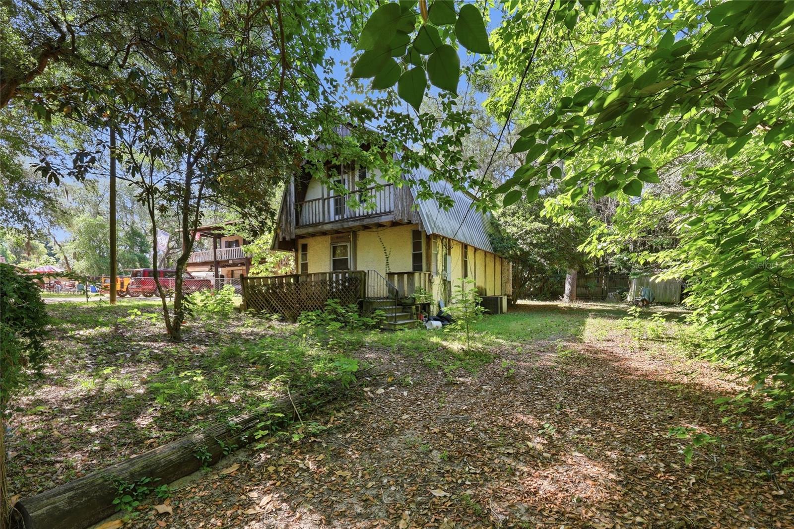 Opportunity awaits in the charming town of Umatilla! Tucked away on private dirt roads and surrounded by mature landscaping, this 1 bedroom, 2 bath, two story home offers approximately 1,200 square feet of potential and privacy. Whether you are looking for your next investment project, weekend retreat, or a place to create your own vision from the ground up, this property is full of possibilities.

The home is in need of updates and repairs, making it an ideal fixer upper for buyers ready to bring their creativity and personal touch. Enjoy the peaceful small town atmosphere that Umatilla is known for, while still being conveniently located near lakes, outdoor recreation, and the natural beauty of Central Florida. With its quiet surroundings and hidden away feel, this property offers a unique opportunity to transform it into something special.