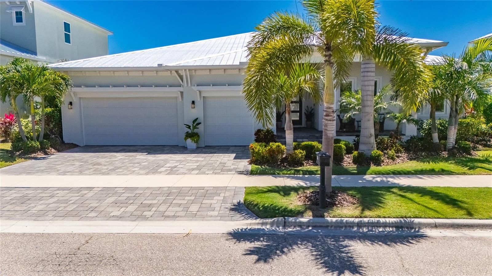One or more photo(s) has been virtually staged. 5704 Tybee Island Drive, Apollo Beach | 4 Bedrooms | 3 Bathrooms | 2,733 Sq Ft | Waterfront Pool Home | MiraBay | Built 2022 | Bistro Builders
This one-story Key West-style pool home sits on approximately 80 feet of saltwater canal frontage in the gated MiraBay community of Apollo Beach, with direct boating access to Tampa Bay and no fixed bridges of lifts between your dock and open water. The private dock and lift, in-ground pool, and covered outdoor living areas with wood ceilings make this one of the most complete High-end newer waterfront packages in the neighborhood.
The exterior is finished with professional uplighting front and back, lighted dock, retaining wall lighting, and an outdoor kitchen with quartz waterfall edge countertops under a covered lanai with wood ceiling. The 3-plus car garage has loads of customized easy access storage and provides room for vehicles, golf carts, and water gear. A metal roof, HVAC, and tankless water heater are all approximately three years old, and foam insulation keeps efficiency high year-round. The home also carries natural gas service, whole-home water softener, Honeywell security system, and fiber internet capability.
Inside, the open-concept floor plan delivers 12-foot ceilings, crown molding, tray ceilings, and Gorgeous imported tile flooring in the main living areas. A whole-home audio system runs through ceiling speakers in nearly every room and the lanai. The kitchen features quartz waterfall edge countertops, stainless steel appliances, built-in oven, cooktop, an oversized center island, extra-large walk-in pantry, built-in butler's pantry, and wine bar. The primary suite at the rear of the home carries canal views, a custom California closet, enormous walk-through shower with floor-to-ceiling imported tile and multiple shower heads, dual sinks, and a cozy soaking tub. A private guest suite with ensuite bath and two secondary bedrooms sharing a full bath complete the split floor plan. A dedicated office adds flexibility for remote work.
MiraBay amenities include two heated pools, lounge, a poolside cafe, 24-hour fitness center, tennis, pickleball, and basketball courts, parks, trails, a private boat launch, and free community kayaks and paddleboards. The HOA is approximately $190 yearly. Tampa International Airport is under 30 minutes. Downtown Tampa and St. Petersburg are each within 30 to 40 minutes.

**What the Seller Loves: There is something about pulling out of this canal in the morning with no bridges between you and open Tampa Bay water that never stopped feeling like a privilege. We chose this lot specifically for the 80 feet of frontage and the clean run to the bay, and it delivered every single time. Quick runs in the evenings to the flats to watch the sunset will be memories we never forget. The outdoor living spaces are where we spent most of our time, the wood ceiling on the lanai, the outdoor kitchen, the pool with the canal right there. The neighbors on Tybee Island Drive are genuinely great and we are going to miss this street.
