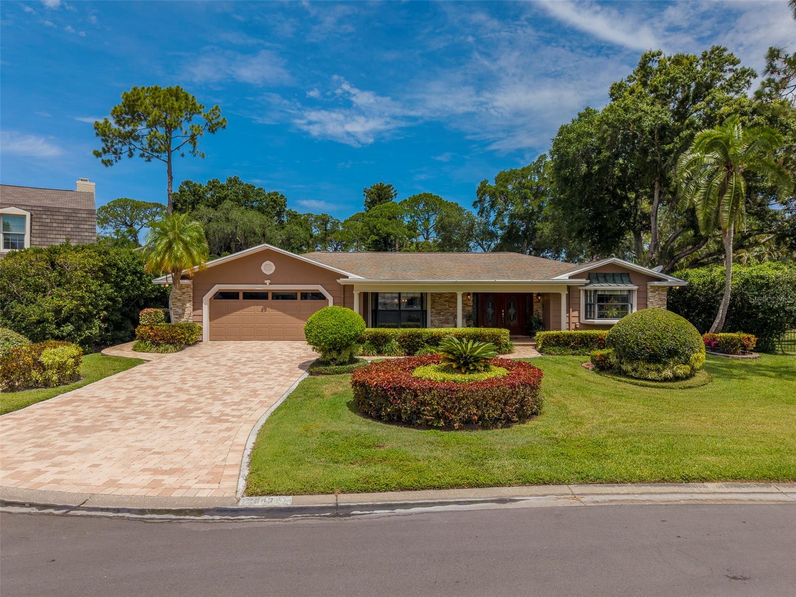 Welcome to this exceptional 4-bedroom, 4-bathroom pool home nestled on a nearly 1/3-acre oversized cul-de-sac lot in the highly desirable Feather Sound Country Club community. Offering timeless elegance, spacious living areas, and outstanding updates, this residence showcases pride of ownership throughout. As you arrive, you'll be impressed by the stunning curb appeal featuring lush tropical landscaping, a paver driveway, a grand covered front porch, and an inviting double-door entry. Situated on one of the community's elevated lots, the home remained high and dry with no flooding during the 2024 storms, providing valuable peace of mind.
Designed for both everyday living and entertaining, the heart of the home is the beautifully appointed kitchen featuring granite countertops, real wood cabinetry, stainless steel appliances, built-in ovens, and an induction cooktop. The thoughtful floor plan flows seamlessly into multiple living spaces, including formal living and family rooms, each enhanced by a cozy gas fireplace and an enclosed Sunroom .
Step outside to your private backyard retreat where a gorgeous saltwater pool with PebbleTec finish is surrounded by mature landscaping and expansive outdoor living space, creating the perfect setting for relaxation or entertaining family and friends.
The spacious primary suite serves as a true sanctuary, complete with a luxurious bath featuring a sunken soaking tub, shower combination, and a skylight that fills the space with natural light. The home offers exceptional flexibility with three ensuite bathrooms throughout, including an oversized secondary primary suite featuring a large walk-in closet and elegant French doors that open directly to the pool and backyard. Additional features include an interior laundry room conveniently located off the two-car garage, a security system, water softener, and numerous major system updates. The roof was replaced in 2012, the two-zone HVAC systems were replaced in 2014 and 2021, and both the water heater and pool pump are approximately three years old. Residents enjoy access to the renowned Feather Sound Country Club, which offers an 18-hole championship golf course, tennis facilities, social memberships, clubhouse pool, dining venues, and event spaces available for weddings and special occasions. Memberships are available but optional, and notably, the community has no HOA fees. Feather Sound is known for its beautifully maintained green spaces, scenic bike trails, parks, and welcoming atmosphere. Conveniently located near I-275, you'll enjoy easy access to Tampa, Downtown St. Petersburg, Tampa International Airport, and Pinellas County's world-renowned Gulf beaches. Shopping, dining, and everyday conveniences are all just minutes away. This remarkable home combines space, comfort, quality updates, and an unbeatable location. Don't miss your opportunity to make this beautiful Feather Sound family home your own.