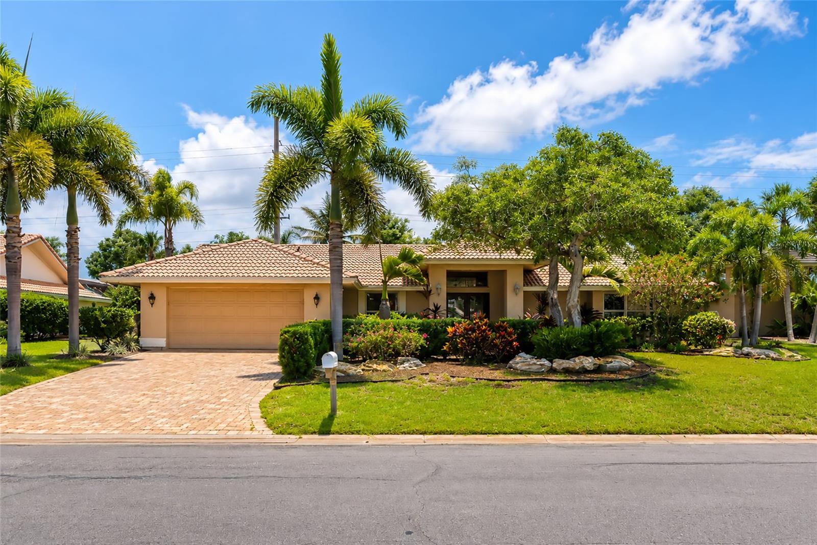 Wow!  What a great price for this 2,474 square foot home in the sought after neighborhood of Southbay Yacht and Racquet Club.  Unique “U” shape design gives a unique courtyard feel to the pool and lanai area.  Enter into the foyer with travertine flooring and look straight ahead to the pool courtyard.  This home is perfect for entertaining with the living room used as a game room with your own pool table.  Dining room offers a built in bar area.  Nicely equipped cherry kitchen opens to family room with fireplace and sliding glass doors onto the courtyard. Travertine floors are also in the diningroom, kitchen and family room. The primary suite is located on one side of the home while the other two bedrooms are on the other side. The primary suite also looks onto the pool area.  The large courtyard offers plenty of covered space for lounging plus solar heated pool, and an above ground hot tub!  All furniture can be left with the home and is negotiable if you are looking to move right in and start enjoying the fabulous Florida lifestyle.  OTHER BENEFITS OF THE HOME INCLUDE RECENTLY REPLACED A/C, A GENERATOR, ROOF APROX. 13 YEARS OLD, POOL RESURFACED IN 2009.  Speaking of lifestyle…there is none finer than living in Southbay!  The marina which is exclusive to Southbay residents offers low dock lease fees.  Renovated club house has much to offer including a ballroom, casual “livingroom” areas, two kitchens, fitness center, card room, library, community pool, pickleball courts, tennis courts and activities galore!  Picturesque views, walking trails, kayak launch, kayak storage, playground, bocce ball court and more.  Come explore Southbay, you won’t be disappointed!