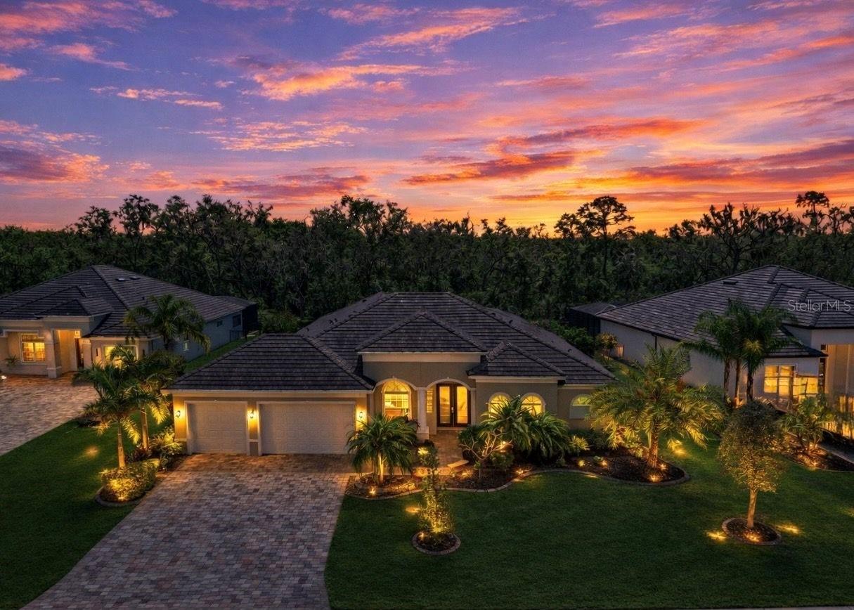 One or more photo(s) has been virtually staged. NEW PRICE!! Welcome to a refined Florida lifestyle where elegant design, privacy, and effortless indoor-outdoor living come together on a nearly half-acre homesite backed up to a preserve within the gated Reserve at Twin Rivers. 

From the moment you arrive, the home’s striking curb appeal captivates, featuring lush, manicured landscaping, a wide pavered driveway, and a three-car garage. Built by Medallion Homes, this residence offers over 4,600 square feet of covered living space, combining timeless craftsmanship with modern peace of mind, including HURRICANE-IMPACT WINDOWS AND SLIDERS throughout, a TILE ROOF, GUTTERS and a brand-new WHOLE-HOUSE GENERATOR powered by a 500-GALLON BURIED PROPANE TANK.

Step inside to discover elegant architectural details, with TRAY CEILINGS and CROWN MOLDING throughout. The front of the home features a formal dining room, inviting sitting room, and a private office with glass French doors and built-in shelving. Ideal for hosting guests or working from home.

Toward the back, the home opens effortlessly to the outdoors. Sliders from the living room, kitchen, primary suite, and bonus room provide seamless access to a resort-style lanai, HEATED SALTWATER POOL, and SPA. Surrounded by lush palms for privacy, the lanai includes an OUTDOOR KITCHEN, the perfect for alfresco dining, entertaining, or relaxing in a tropical retreat.

The kitchen is both beautiful and functional, featuring a large cooking island, upgraded cabinetry, quartz countertops, bar-top seating, a walk-in pantry with built-in shelving, and a butler’s pantry. The café dining area is highlighted by an aquarium window, bringing a touch of nature inside.

The split floor plan offers privacy and comfort. The primary suite is a serene retreat with sliders to the pool, dual walk-in closets, and a spa-inspired en-suite bathroom with dual vanities, a dedicated makeup area, large walk-in shower, and a private water closet with a separate porcelain bidet. Two bedrooms share a Jack-and-Jill bath with tub, while a fourth bedroom near the bonus room enjoys a full pool-access bathroom with shower.

The BONUS ROOM, located off the living room, is a true showpiece featuring a COFFERED ceiling, BUILT-IN BAR with WINE REFRIGERATOR, dramatic STACKED STONE ACCENT WALL, BUILT-IN ELECTRIC FIREPLACE, and sliders opening directly to the lanai and pool. The perfect place for entertaining or unwinding.

Located in a GATED community with NO CDD fees and low HOA FEES THAT INCLUDE CABLE AND INTERNET, this exceptional property offers rare privacy while remaining close to Parrish, Bradenton, Lakewood Ranch, premier shopping and dining, and the Gulf Coast beaches.

This is refined Florida living at its finest where elegant interiors, expansive indoor-outdoor spaces, and thoughtful upgrades create a truly extraordinary place to call home.
CLICK on the links for VIDEO and 3D TOURS!