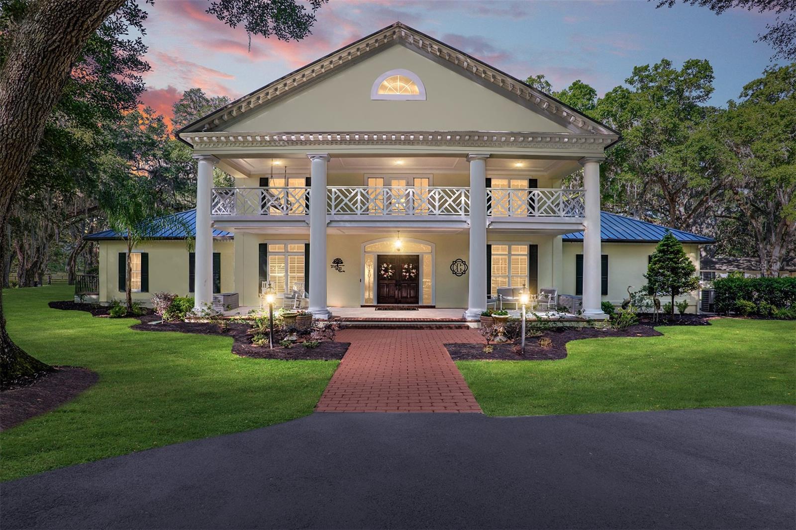 Welcome to Breath of Heaven Ranch, a hidden paradise behind elegant gates. Picture yourself driving down the softly lit path, where every turn unveils a new facet of beauty. Nestled on a sprawling 124-acre gentleman's estate, this stunning home has undergone a beautiful renovation.
As you step inside, the grandeur of the entrance captures your imagination. A graceful staircase leads to a balcony overlooking three bedrooms, each a haven of comfort and style. Imagine waking up to the gentle morning light filtering through the windows, offering a panoramic view of the estate's lush landscapes and majestic live oaks.
Entertaining becomes an art in the formal dining room, seamlessly connected to the updated kitchen, where hosting large gatherings is a delight. The living room invites cozy evenings by the fireplace, accented by plantation shutters and intricate crown molding.
The heart of the home, the family room, and kitchen, beckons with expansive windows framing picture-perfect sunsets. Here, wildlife becomes a part of your daily scenery, adding a touch of serenity to every moment. The kitchen, a chef's dream, boasts new cabinets, granite countertops, and top-of-the-line appliances centered around an inviting island.
Retreat to the primary bedroom sanctuary, where wood floors lead to a sitting room and walk-in closets. The en-suite bathroom is a spa-like oasis, featuring a walk-through shower, dual sinks, and a screened balcony with a sun deck overlooking the pool. There are two guest bedrooms overlooking the balcony with a guest bathroom.
Outside, the ranch beckons with its amenities—a turn-key cattle and equestrian paradise. Imagine the possibilities of the half-enclosed pole barn, the expansive metal building, and the peaceful guest home. A gazebo offers a tranquil spot to unwind, while a diesel generator ensures comfort even during power outages.
Conveniently located minutes from Gainesville and a short drive to Ocala's premier equestrian destinations, Reath of Heaven Ranch is more than a home; it's a lifestyle waiting to be embraced. Schedule your private tour to experience the magic firsthand and discover the countless features and updates that make this estate exceptional.