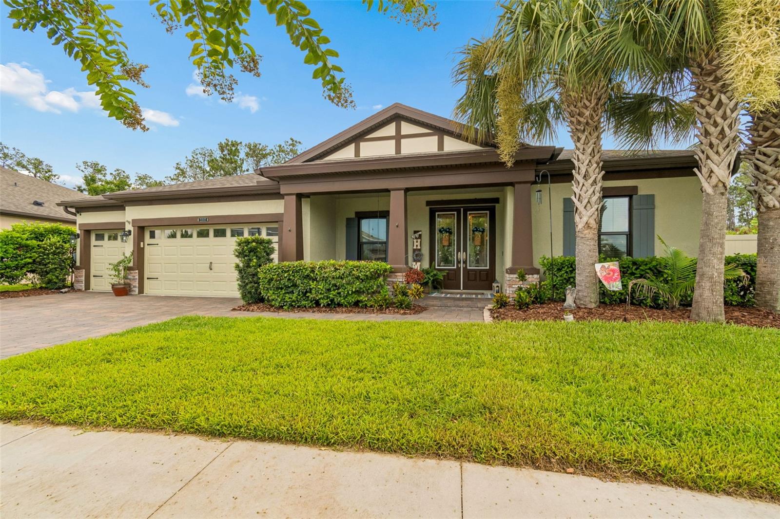 Built in 2019, this exceptional single-story home in the award-winning Connerton community offers 4 bedrooms, 3 bathrooms, a private office, flex/media room, 3-car garage, and 3,227 square feet of thoughtfully designed living space. The open-concept floor plan features a gourmet kitchen with quartz countertops, a large center island with seating on three sides, farmhouse sink, built-in oven and microwave, walk-in pantry, and a custom built-in dining room buffet with glass display cabinetry and storage. The spacious living room overlooks the resort-style backyard, creating the perfect space for everyday living and entertaining. The split-bedroom layout provides privacy, with a luxurious primary suite offering private lanai access, an oversized walk-in closet, and a spa-inspired bath featuring dual vanities, a garden tub, walk-in shower, and private water closet. Three additional bedrooms, two full bathrooms, a versatile flex/media room with limestone patio access, and a spacious laundry room with utility sink complete the interior. Outdoor living is where this home truly shines. Enjoy peaceful conservation views with no rear neighbors from your custom infinity-edge pool and spa featuring bubblers, LED lighting (Pool features controlled by Pentair pool app). The outdoor entertainment area includes a natural gas outdoor kitchen beneath a hard-top pergola, built-in propane fire pit beneath draping string lights, premium turf, covered playground, Vego raised garden beds with automated irrigation, French drain, and an automated mosquito misting system with low-level monitoring making outdoor living even more enjoyable.
Additional features worthy of mention include a reverse osmosis water filtration system, tankless water heater, structured smart-home technology hub (for home features controlled through an application) brand-new Mohawk carpet in all bedrooms with transferable warranties, and a turf vacuum that conveys with the home. Residents of Connerton enjoy resort-style amenities including multiple community pools, splash park, fitness center, tennis and pickleball courts, basketball courts, walking and biking trails, dog parks, playgrounds, and year-round community events. Conveniently located near shopping, dining, medical facilities, top-rated schools, and major commuter routes, this home offers the perfect blend of luxury, comfort, and convenience.