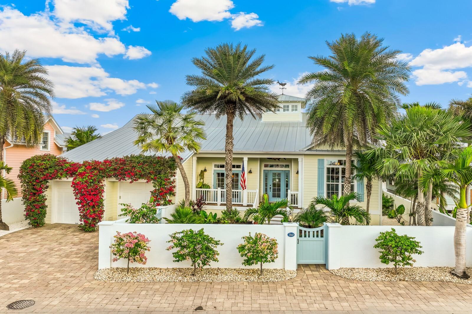 Nestled in the heart of Boca Grande's charming historic district, just steps from downtown amenities, this impeccable custom-built home offers the epitome of luxury island living. Constructed in 2012, architecture by T.A. Krebs with unparalleled craftsmanship and attention to detail, this move-in-ready home exudes timeless elegance and modern sophistication. Upon entering, you are immediately captivated by the soaring 24-foot cupola and exquisite 6-inch tongue-and-groove board ceilings, setting a grand tone for the open and inviting interior. The home features three spacious bedrooms and four and a half well-appointed bathrooms, providing ample space for family and guests. Cozy up by one of two stunning brick fireplaces—one gracing the living room and the other in the serene primary bedroom. Throughout, luxurious travertine and wood flooring flows seamlessly, complemented by granite countertops in the gourmet kitchen. Equipped with top-of-the-line Wolf and sub-zero appliances, a convenient garden sink, gas stove, gas oven, and generous pantry, this kitchen is a chef's dream. French doors seamlessly connect the interior to the outdoor oasis: a brick-paved patio overlooking a heated pool and spa and a dedicated pool bathroom for ultimate convenience. Additional highlights include a large upper-level bonus room ideal for extra sleeping or living area or relaxation, durable Hardy board siding, all impact-resistant glass windows and doors for peace of mind, a 2+ car garage, and lush, mature landscaping that envelops the property in privacy and natural beauty. Truly a rare gem in the heart of Boca Grande, this exceptional home blends historic charm with contemporary luxury—ready for you to call it your own.