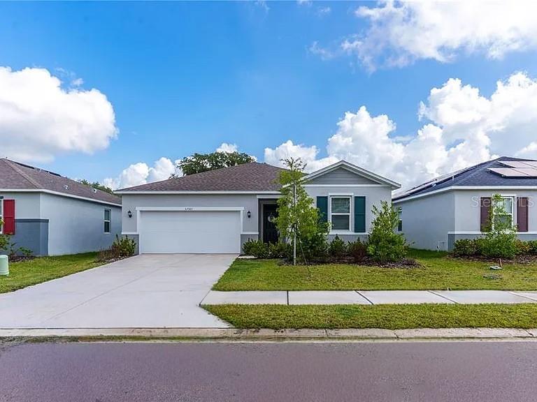 ASSUMABLE VA LOAN!! Beautifully designed for modern living, this charming single-story home offers an open, functional floor plan with luxury vinyl plank flooring throughout the main living areas and wet spaces. The spacious kitchen is the heart of the home, featuring 42-inch cabinetry, granite countertops, a classic subway tile backsplash, a large eat-at island, and a stainless-steel Whirlpool appliance package, making it ideal for both everyday living and entertaining. The private primary suite is tucked away at the rear of the home and includes a generous walk-in closet and an en suite bath with dual granite vanities, a linen closet, Moen Water Sense fixtures, and a beautifully tiled walk-in shower. A desirable split-bedroom layout provides added privacy, with two secondary bedrooms located at the front of the home, each offering ample closet space. Conveniently located with quick access to US-301, I-75, and State Road 56, this home is perfect for commuters while still offering a peaceful neighborhood setting. With no CDD fees and a low HOA, this move-in-ready home combines style, comfort, and exceptional value, making it an opportunity you won't want to miss.