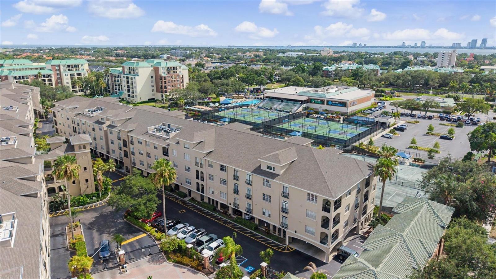 Experience upscale urban living in the heart of highly sought-after Harbour Island in this beautifully maintained 2-bedroom, 2-bath condominium offering 1,073 square feet of comfortable living space within the gated Harbour Place City Homes community. Ideally situated on the second floor with convenient elevator access, this residence features a desirable split-bedroom floor plan designed for both privacy and functionality.

The spacious kitchen is a chef's delight, showcasing granite countertops, abundant cabinetry, a breakfast bar, and a charming dinette area perfect for casual dining. The open-concept design flows effortlessly into the bright and inviting living room, where large windows fill the space with natural light and create a warm, welcoming atmosphere. Crown molding and ceiling fans add tasteful finishing touches throughout the home.

The generously sized primary suite offers a walk-in closet and a private ensuite bathroom, creating a peaceful retreat. The spacious secondary bedroom also features a walk-in closet and is conveniently located adjacent to the second full bathroom, making it ideal for guests or a home office. An inside utility area with a washer and dryer is included for added convenience. Enjoy peaceful views overlooking the Life Time Club and tennis courts, while your assigned parking space in the secured garage provides ease and security.

Harbour Place City Homes offers an exceptional collection of resort-style amenities, including a sparkling swimming pool with cabanas, grilling area, fitness center, clubhouse, business center, and a convenient car wash station with vacuums. Beautifully landscaped grounds and secure gated entry create an inviting community atmosphere surrounded by some of Tampa's most prestigious residences.

Located just steps from Water Street, Sparkman Wharf, Amalie Arena, the Tampa Riverwalk, Channelside, and Downtown Tampa, you'll enjoy an unmatched walkable lifestyle with premier restaurants, shopping, entertainment, and waterfront attractions right outside your door. With easy access to major highways, Tampa International Airport, hospitals, top-rated schools, and the city's thriving business district, this exceptional Harbour Island residence offers the perfect combination of luxury, convenience, and vibrant urban living.