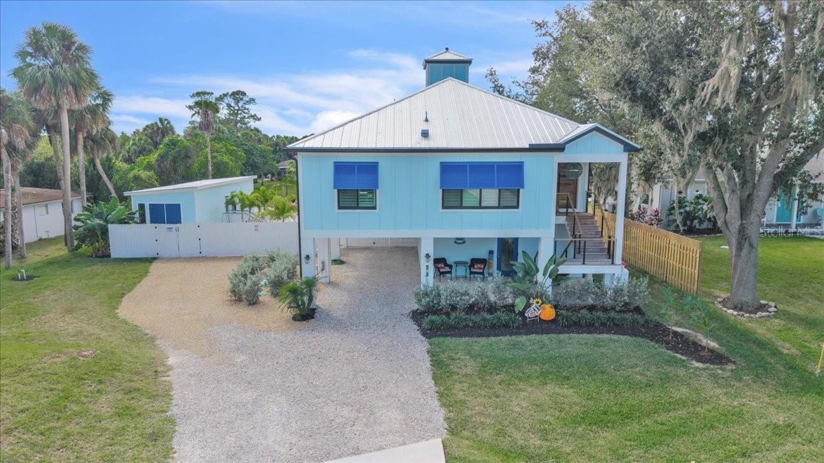 Waterfront living at its finest, must see to truly appreciate! Experience the ultimate Florida coastal lifestyle in this one-of-a-kind waterfront retreat offering three separate living spaces and exceptional income or multigenerational potential. Perfectly positioned along 100 feet of canal frontage, this property delivers a true private resort setting with direct water access from canal to Caloosahatchee River  and an expansive sandy beach framed by swaying palms, hammocks, and a custom fire pit. The main residence, located on the upper level, features 2 bedrooms and 2 full bathrooms with custom-milled wood flooring throughout. A chef’s kitchen anchors the home, complete with a 12-foot island, natural gas 48-inch range with dual ovens, wine cooler, and a walk-in pantry. Expansive sliding glass doors open from both the primary suite and main living areas to a large elevated deck, seamlessly blending indoor and outdoor living. The lower level of the main home includes a private 600-square-foot apartment or in-law suite with its own entrance, kitchenette, full bathroom, and covered porch—ideal for guests or rental use. A detached guest cottage offers a third independent living space, featuring an open-concept layout with kitchenette, private laundry, full bathroom, and its own porch set directly along the sand. Designed for entertaining, the outdoor living area showcases a resort-style pool with a swim-up bar, connected to a custom tiki hut, creating a true Florida-inspired gathering space. Whether utilized as a primary residence, vacation home, or income-producing property, this unique offering captures the essence of waterfront living with unmatched versatility and lifestyle appeal.