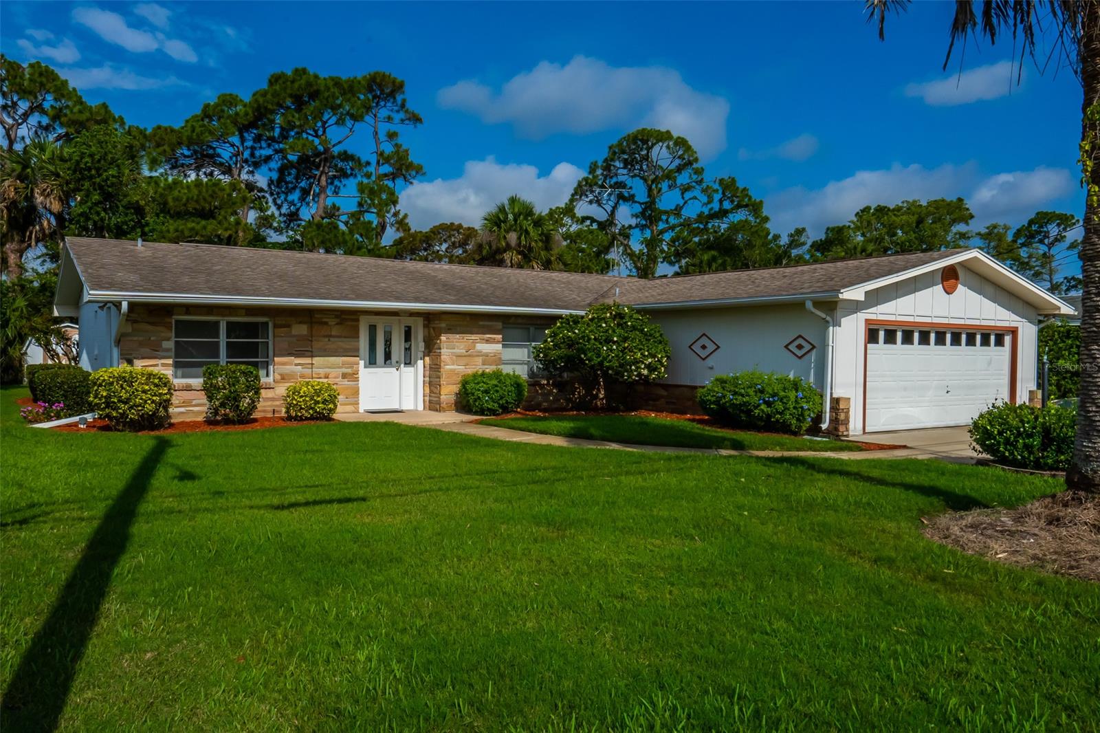 Attention golfers! Two golf courses are minutes away from this 3 bedroom 2 bathroom home located in the Fairgreen area. Built in 1968, this canal front home has a vintage flare with original touches throughout.   Upon entering, you will be greeted by an open floor plan with a Florida room that highlights six sliding glass doors that look out to a large covered patio, lush Florida landscaping and a waterway that leads out to Rose Bay and Spruce Creek.  This split floor plan features a large master bedroom, bathroom and a walk-in closet and two bedrooms that share a bath as well as access from the hallway.  Open kitchen features a brick accent wall, pantry and room for a table.  Bring your kayak, canoe, fishing poles, even a small boat and enjoy the sights and sounds of Florida nature! The oversized garage has loads of built-in storage cabinets. A 10x10 shed in the backyard is perfect for lawn equipment and more storage.  In addition, there is a four-zone sprinkler system.  Brand new outside GE meter, and a new Siemens electrical panel installed May 2020.  4 MILES FROM THE BEACH AND NO HOA! ;Water: City