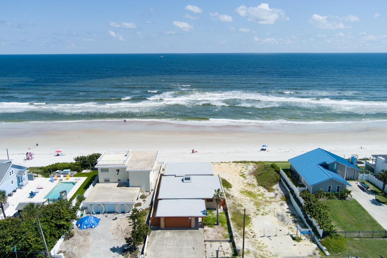 Oceanfront Fixer Opportunity in Wilber-by-the-Sea! This 3-bedroom, 2-bath single-family home offers direct oceanfront living with endless potential. NEW SEAWALL & NEW ROOF is already in place, setting the stage for your vision to restore, renovate, or rebuild your dream coastal retreat. Inside, you'll find both a large great room overlooking the ocean and a living room, plus a versatile bonus space and an inside laundry room. The spacious layout provides plenty of options while capturing sweeping Atlantic views. Rare chance to own on the ocean in sought-after Wilber-by-the-Sea—no HOA! Interior photos coming.