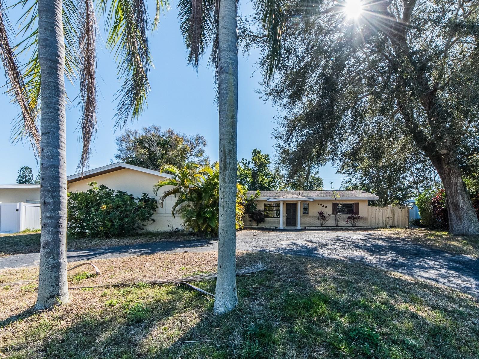 Discover this move-in-ready 3-bedroom, 2-bath home ideally situated in one of Belleair Bluffs’ most desirable and well-established neighborhoods, known for its central location and easy access to everything Tampa Bay has to offer. Light-filled and inviting, the home features newer flooring throughout and a spacious living area that flows seamlessly into the open dining space and remodeled modern kitchen. Designed for both everyday living and entertaining, the kitchen is equipped with newer stainless-steel appliances and generous workspace, creating a natural gathering spot in the home. The thoughtfully designed split-bedroom layout provides privacy, with a comfortable primary suite featuring built-in closet storage and an en-suite bath with a large walk-in shower. A Florida room adds versatile bonus space. The two car garage is wonderful to keep your car cool in our hot summer. Outdoors, enjoy a fully fenced backyard that is pet friendly and perfect for relaxing or letting pets play freely. Ample parking is available with an attached garage and circular driveway, offering space. Located in a non-flood zone, this exceptional Belleair Bluffs home places you minutes from top-rated restaurants, boutique shopping, grocery stores, public boat ramps, and everyday conveniences, while being just a quick drive over the Belleair Bridge to the sugar-sand beaches of the Gulf of Mexico. No smoking permitted. Tenants are responsible for lawn care, water, trash, electric, and cable/Wi-Fi. This is a rare opportunity to enjoy a spacious, well-appointed home in an exclusive, centrally located coastal community where convenience, comfort, and lifestyle come together.