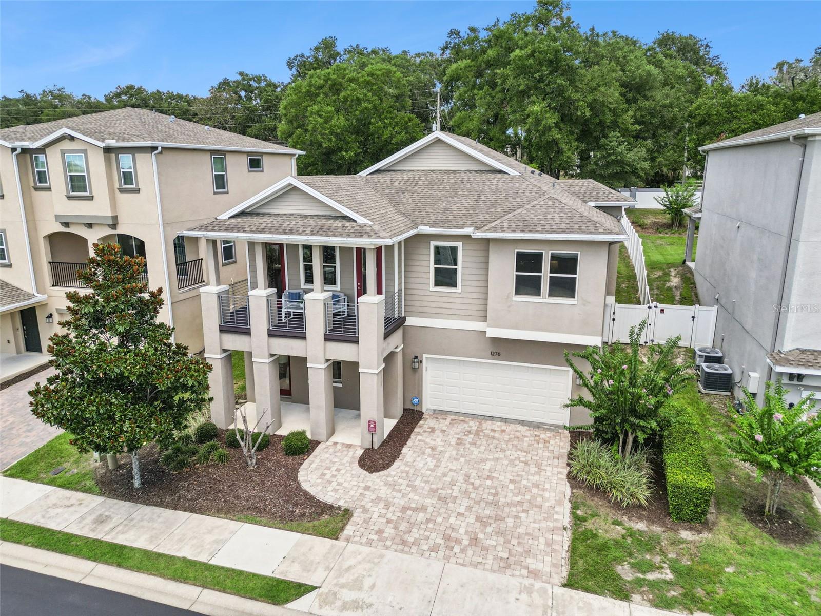 BOTTOMS UP!  Luxury Living in Mount Dora... Elevated!  Designed around today's modern lifestyle, this extraordinary home flips the traditional floorplan upside down—in all the best ways. The result? A home that gives off serious penthouse vibes while the lower level offers incredible flexibility for guests, extended family, or turn it into the ultimate entertainment retreat.  Who says life has to be lived on the first floor?  This spectacular Mount Dora Home with a PRIVATE ELEVATOR, makes life a breeze, especially if you just don't want to take the stairs!  This home was no "production build" and it shows, with upgrades & updates not typically found in homes built by a large production builder.  Built in 2016 by respected builder, A.R. Bailey, no expense was spared in the construction & design, as this was the former Model Home for the community at its inception. What makes this home stand out from the rest will be evident from the moment you enter.  This isn't just a home with two levels... it's a home with two lifestyles.  Upstairs...Luxury entertaining, Views, Coffee or Happy Hour on the Balcony, Dinner parties, collaborative cooking, garden parties outside w/ access to al Fresco Dining under the pergola & wood-burning fireplace beneath the stars.  Downstairs...Guests with their own private retreat en suite, Parents and/or Grandparents suite for extended stays, Home Gym? Media room? Home Office ...you decide! 
The oversized, tiled-floor FOUR-CAR tandem garage offers endless possibilities. Imagine a private fitness studio, golf simulator, luxury car collection, workshop, or the ultimate hobby space—without sacrificing room for your vehicles.  There is even a cooled storage area in the back of the garage that has been used in the past as a safe room/quiet space. AND....Kiss those worries goodbye during Hurricane Season or during those famous Florida thunderstorms!  This home also comes with a WHOLE-HOME Generac natural gas generator!  Warning! ....You'd better be Costco-ready, because all your family & friends will want to ride out the storm at YOUR house!  
As an added perk, you'll also enjoy a lock-and-leave lifestyle with HOA-maintained grounds, all with the peace of mind that a gated community offers. With an enviable location, only about a mile of sidewalks away from downtown Mount Dora's storied shops, boutiques, restaurants, galleries, museums and world-famous Art Festivals & community events.  There is also a community boardwalk to your lake access to Lake Dora inside Dora Parc...Live that "Lake Lifestyle", without the waterfront price tag! Enjoy effortless weekends exploring the Harris Chain of Lakes. Rent a pontoon for the day or keep your own boat nearby in covered storage at the Mount Dora Boating Center & Marina.  Spend the afternoon cruising to waterfront restaurants—all just minutes from your front door.  Can life be any sweeter!? You'll need to see this one in-person to see & appreciate all the bells 'n whistles! You'll want to make this cream-puff HOME...but HURRY!  Call today for your private tour!