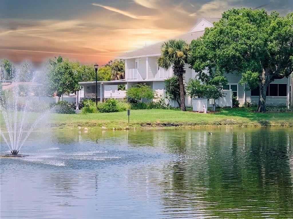 Unpack, pour a coffee, and watch the morning light on the pond. This move-in-ready 2-bedroom, 2-bath corner condo in Tampa's Savannah Trace delivers pond views from the living room, primary bedroom, and a private covered balcony — and in a market full of Tampa condos facing milestone inspections, it's the exception: a two-story building, EXEMPT from milestone requirements, with a financially solid association and a low monthly fee. The 2023 kitchen shines with shaker cabinets, granite counters, a tile backsplash, and stainless appliances; the primary shower was updated in 2025; and luxury vinyl & tile runs throughout. Second-floor corner unit with all living space on one level, 2023 hurricane-impact windows, 2018 A/C, a covered carport plus an assigned space, a storage unit, and a vinyl-fenced courtyard. All appliances convey, washer and dryer included. Lease from day one (association approval required) makes it investor-friendly, too. Minutes from Tampa International Airport, the Veterans Expressway and I-275, the Westshore Business District, and International Plaza, with Ben T Davis Beach close by and downtown Tampa 15–20 minutes out. Available for a quick close.