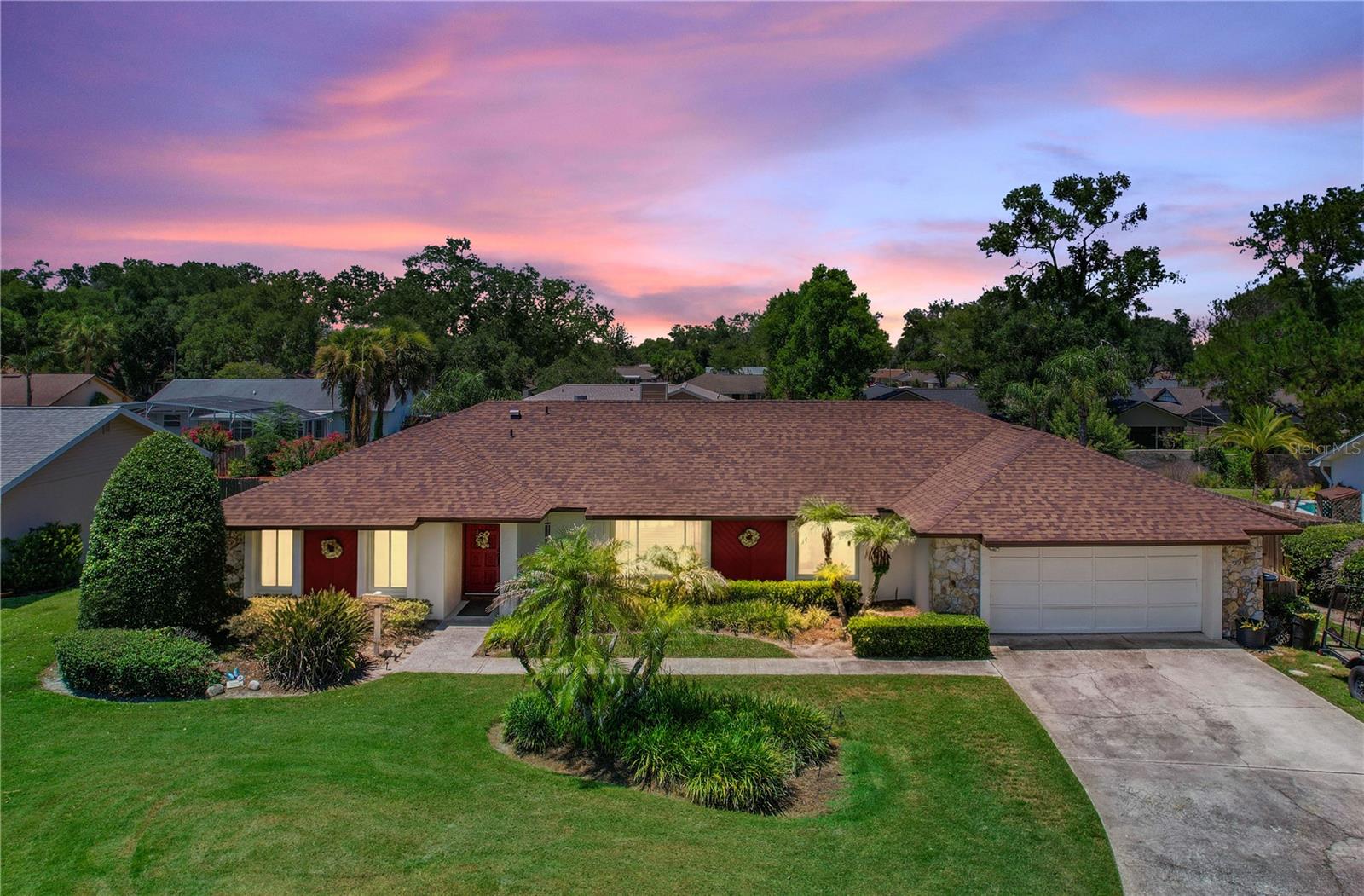 Welcome to 1540 Tracy Dee Way, a 4-bedroom, 3-bathroom pool home located in the popular Jennifer Estates community of Longwood. Beautiful curb appeal welcomes you with a wide front lawn, mature landscaping, lush palms, manicured hedges, a spacious driveway, a 2-car garage, stone accent details, and a warm exterior with a red front door and shutters that add character. Inside, the welcoming entryway features a wood front door, side glass panel, coat closet, and tiled foyer that opens into the main living areas. The spacious family room offers warm wood flooring, a striking fireplace with custom wood built-in shelving and cabinetry, and French doors leading directly to the outdoor living area and pool. Additional living and dining spaces feature large front-facing windows, neutral wall tones, and a flexible open layout filled with natural light. The kitchen offers abundant bright cabinetry, generous counter space, recessed lighting, tray ceiling detail, tile backsplash with warmth and texture, a breakfast bar with a double sink, and easy flow to the dining area and breakfast nook. The spacious primary bedroom features soft carpet, neutral tones, generous closet storage, an ensuite bathroom, natural light, and direct access to the outdoor patio area. Bedroom 2 offers its own ensuite bathroom, while bedrooms 3 and 4 share the third bathroom, creating a functional layout with added flexibility for family, guests, or a home office. The backyard offers a true Florida retreat with a sparkling private pool, expansive paver deck, fully fenced yard, beautiful landscaping, and plenty of green space to relax, entertain, and enjoy your own private backyard oasis. Jennifer Estates offers a community boat ramp to popular Lake Brantley and is just minutes to Wekiva Springs State Park, major roadways, shopping, dining, and popular Central Florida attractions. Recent updates include roof 2024, HVAC 2025, pool pump 2026, fence 2024, and fireplace roof hood 2026. Zoned for Wekiva Elementary and Lake Brantley High School, this home offers a wonderful opportunity in one of Longwood’s most established and desirable areas.