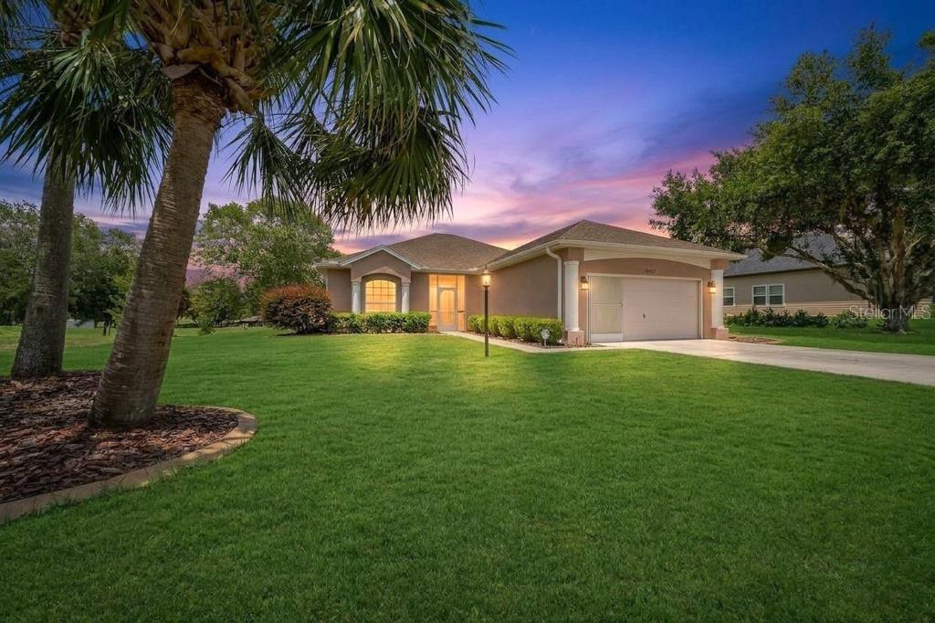 PANORAMIC VIEWS, PRIVACY, GORGEOUS INTERIOR! Be enchanted by this home the moment you walk through the door. The first thing you’ll notice through the double pane triple sliders is the stunning view of year round greenery bordering 20 acres of church property. Thanks to the home’s elevation blue skies become part of this private backyard scene. Large windows throughout fill the home with natural light while directionally situated to minimize direct sun exposure. One side of the property features a growing viburnum privacy hedge, while the other side borders common property, creating an extra spacious feel with very little neighboring visibility.Vaulted ceilings in the main living area and 9 foot ceilings throughout enhance the open and airy design. Unlike the typical cookie cutter layout, this home blends open concept living with warmth, character, and architectural charm.The spacious kitchen offers abundant wood cabinetry, a new appliance suite, and an adjoining dining area that flows seamlessly into the main living space. The primary suite features two sliders leading to the screened lanai, a walk in closet, and an oversized walk in shower designed for both luxury and accessibility. Two additional bedrooms and a second full bath provide flexibility for guests, a home office, or additional living space. A dedicated laundry room includes new washer and dryer, shelving, and closet for extra storage. The screened lanai is also wired for a hot tub. Built with durable masonry construction rather than wood frame, this home offers added strength, insulation, and lower insurance costs. Additional upgrades include recessed LED lighting, designer fixtures, professional interior paint, new LVP flooring, AC replaced in 2022, exterior paint completed in 2021, irrigation on a separate meter, and a screened front entry. Plus, the property is located in a NO FLOOD ZONE for added peace of mind.The mature landscaping adds tremendous value and curb appeal with paver accents, established shrubbery, towering palms, and even a delicious loquat fruit tree in the backyard. Located in the nature focused community of Rainbow Springs, this home is only a mile away from Rainbow Springs State Park where you can enjoy waterfalls, kayaking, tubing, swimming, and scenic nature trails. Residents enjoy exclusive access to a private Rainbow River beach along with the Rainbow Springs Club featuring a community pool, fitness center, tennis courts, pickleball, bocce ball, billiards, restaurant, and year round social activities. Conveniently located near Ocala, and Crystal River, this property offers easy access to shopping, dining, medical facilities, golf, and the renowned World Equestrian Center.Whether you are searching for a full time residence, seasonal retreat, or investment opportunity, this exceptional home offers the perfect combination of beauty, privacy, amenities, and location. Schedule your private showing today and experience the Florida lifestyle this gorgeous home has to offer!