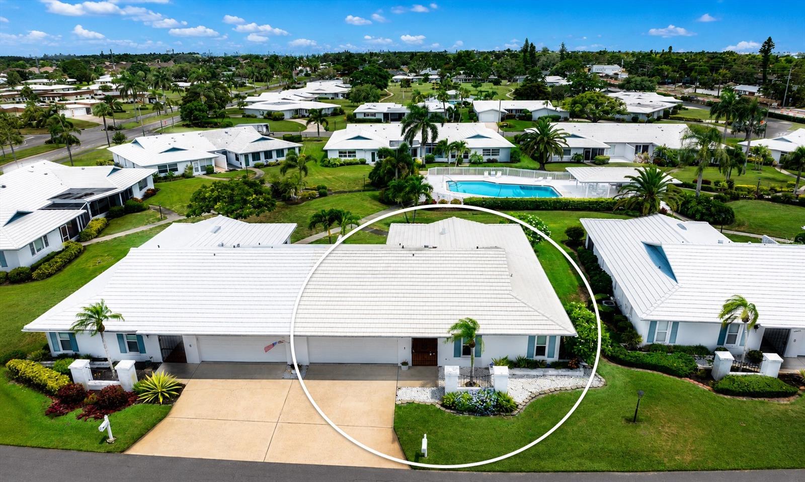 One of the NICEST and BEST VALUED 55+ Village Green Villas with a $25,000 roof credit!!!! 2BR/2BA PLUS DEN/ PLUS BONUS 10X11 ROOM THAT COULD BE 3RD BEDROOM SPACE AND 2 CAR GARAGE. This solid concrete block beauty has 1,913 sq ft of comfortable living space (and 2,413 sq ft under roof) and has room to spread out, chill out, and enjoy the best of coastal living. Highly sought-after “D” model offers maintenance-free 55+ living that truly feels like a single-family home! Notable upgrades include: 2014 hurricane IMPACT windows, 2015 AC and 2024 brand-new luxury vinyl flooring throughout the main living areas, and new stainless steel appliances. Conveys PART Turnkey furnished! Kitchen and both bathrooms are appointed with granite countertops. Full size laundry closet inside. Step outside to enjoy the newly paved patio deck, offering a peaceful retreat to soak up Florida sunshine. The heated community swimming pool and social gathering area are just a few yards away. Unbeatable LOCATION! Just 5 miles from the sugar-sand beaches of gorgeous Anna Maria Island, and moments away from everything that makes West Bradenton amazing: Robinson Preserve, Palma Sola Bay, Cortez Fishing Village, De Soto National Park, G.T. Bray Park, top rated Schools, dining, shopping, Blake Medical Center right around the corner literally, IMG Academy close too! Whether you're lounging poolside, biking scenic trails, or heading out for sunset on the Gulf, this home puts you in the middle of it all. Village Green sits at one of the highest elevations in Manatee County, and no flood insurance is required by lenders. Move-in ready, well-maintained, and perfectly positioned—this is Village Green living at its best. The low Homeowners monthly fee of $675.00 covers the INSURANCE on your building, swimming pool maintenance and pool heater, Spectrum internet and cable, exterior painting of building, manager, pest control, landscaping, weed spraying, all yard maintenance on the outside and annual roof cleaning. Snap up your slice of Florida paradise today!