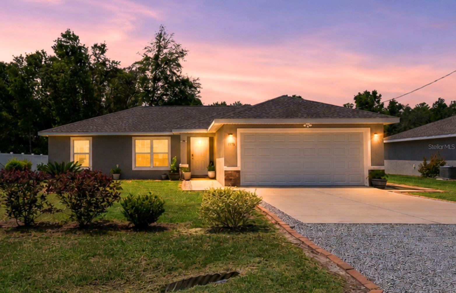 Short Sale. BETTER THAN NEW! Built in 2022 by an established builder, this 3/2 on .22 acres near Dunnellon and the Hwy 200 corridor gives you the clean, modern feel of new construction without the builder-grade bare minimum. OPEN FLOOR PLAN with beautiful granite countertops, a huge granite island, stainless steel appliances, LVP flooring, NO CARPET, tile-surround baths, 2-car garage, water softening system, security system, and a huge walk-in primary closet. The primary bath has been upgraded with modern sliding glass doors, and the living room features upgraded luxury blinds. Outside, the work is already done: landscaping, privacy bushes along the road, extended patio, SunSetter shade, and a finished garage floor. This home has already been through its builder shakedown, which means the little things that often come with new construction have been found, addressed, and improved. Still looks new, but lives better.