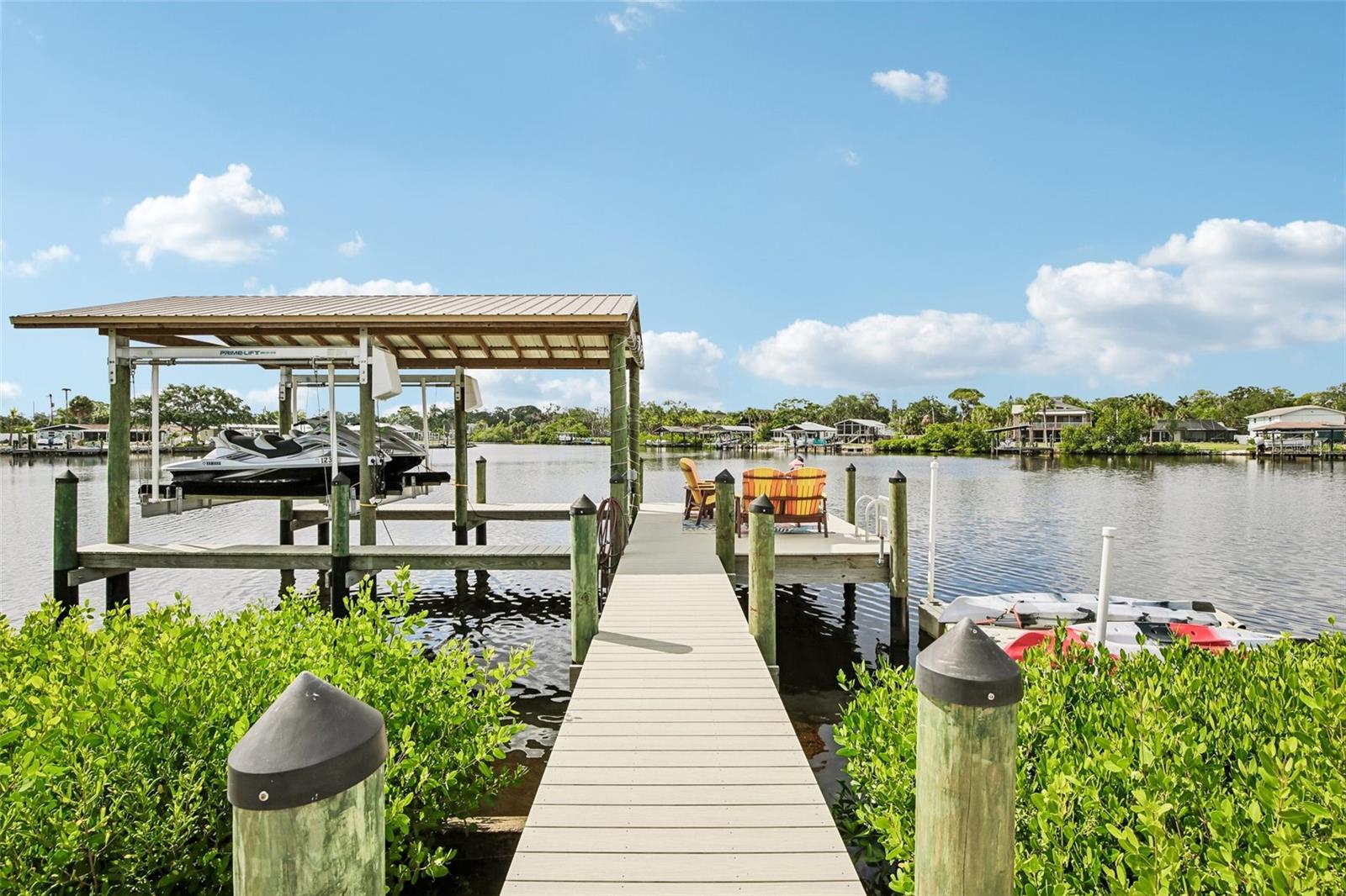 Welcome to the ultimate waterfront retreat! Completely remodeled in 2025, this terrific rambler is classic Florida living. Boasting exceptional curb appeal with its circular driveway, the move-in-ready 3-bedroom, 2-bathroom layout features tile flooring throughout, a bright and spacious living room, a large family room, an inside utility space, and a well-appointed kitchen. The entire home is designed to draw your eyes straight toward the back, where you’re greeted by wide-open, breathtaking views of your Little Manatee River frontage. Step outside onto the massive covered patio—the perfect spot to entertain or unwind—which overlooks an expansive, fully fenced yard with a storage shed, irrigation system,  and plenty of room to add a pool. For boating enthusiasts, the property is a dream come true, featuring a brand-new seawall and a private boat dock with a 10,000-lb lift, offering completely bridge-free access to Tampa Bay and the Gulf. Complete with a new roof, hurricane-rated windows, a new water heater, a water softener, and two 12-foot gates for effortless RV parking, this marvelous home truly has it all.