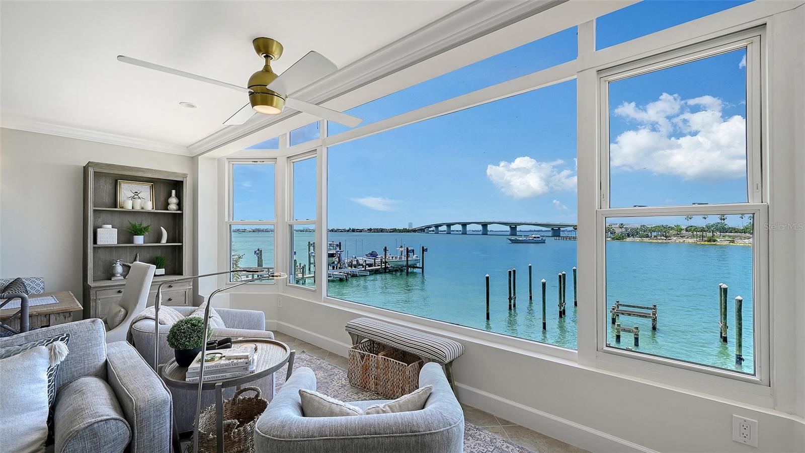 Welcome to 174 Golden Gate Point #22, an exceptional, professionally decorated waterfront residence offered completely furnished for under $1M. Perfectly positioned on the second floor of Sarasota's most prestigious peninsula, this stunning, fully renovated two-bedroom, two-and-a-half-bath condominium captures breathtaking panoramic views of Sarasota Bay and the iconic John Ringling Causeway Bridge from every room. The thoughtful double-primary split floor plan features spacious bedrooms with private en-suite bathrooms, creating a sophisticated yet relaxed retreat ideal for owners and guests alike. Elegant coastal aesthetics, curated by a professional designer using premium pieces from Pottery Barn and Restoration Hardware, blend soft creams and light blues with high-end finishes. Every detail has been meticulously addressed, including crown molding, porcelain tile flooring, quartz countertops, a custom high-end backsplash, accent lighting, powered blinds, a walk-in closet, extensive storage, and a massive TV and sound system.
The main living, dining, and kitchen areas flood with a spectacular natural glow each morning and frame mesmerizing sunset views every evening. Practical amenities elevate the home, including a deeded covered parking spot just one story below that features a handy, built-in storage closet. Embracing an unparalleled downtown Sarasota lifestyle, this property places you at the center of the city’s vibrant cultural and social scene. Enjoy effortless walkability to award-winning restaurants, boutique shops, theaters, art galleries, Marina Jack, Bayfront Park, and a major boat club. You are also just a short trip over the bridge to St. Armands Circle, Lido Beach, and the world-renowned shores of Siesta Key and Longboat Key. With luxury hotels like The Ritz-Carlton and The Westin nearby to accommodate extra guests, this extraordinary property delivers the ultimate combination of luxury, location, and effortless bayfront living. Act fast, as a turnkey opportunity of this caliber on Golden Gate Point for less than $1M may soon be a thing of the past.