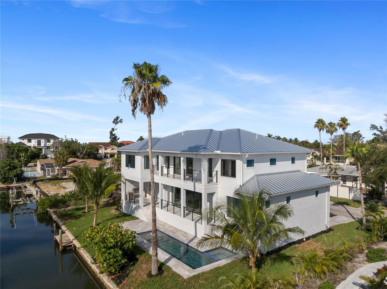 New Construction - Discover the epitome of waterfront luxury with this newly built home in the heart of Longboat Key—competitively priced and move-in ready. Nestled along a private canal, this 4-bedroom plus den, 4,106 sq ft residence blends contemporary sophistication with coastal appeal. Designed for effortless indoor-outdoor living, the home boasts two spacious lanais, a private pool and spa, and an elevated foundation at 9.5 feet for added peace of mind.
Boaters will enjoy concrete canal bulkhead with quick access to the Gulf of Mexico, perfect for endless days on the water. Inside, the home features engineered hardwood flooring, sleek quartz countertops throughout, a large walk-in pantry, and the convenience of dual laundry rooms.
Set in a tranquil, private location just minutes from Longboat Key’s renowned beaches, golf courses, and upscale dining, this home is a rare gem. Don’t miss your opportunity to own a waterfront retreat in one of Florida’s most sought-after coastal communities.