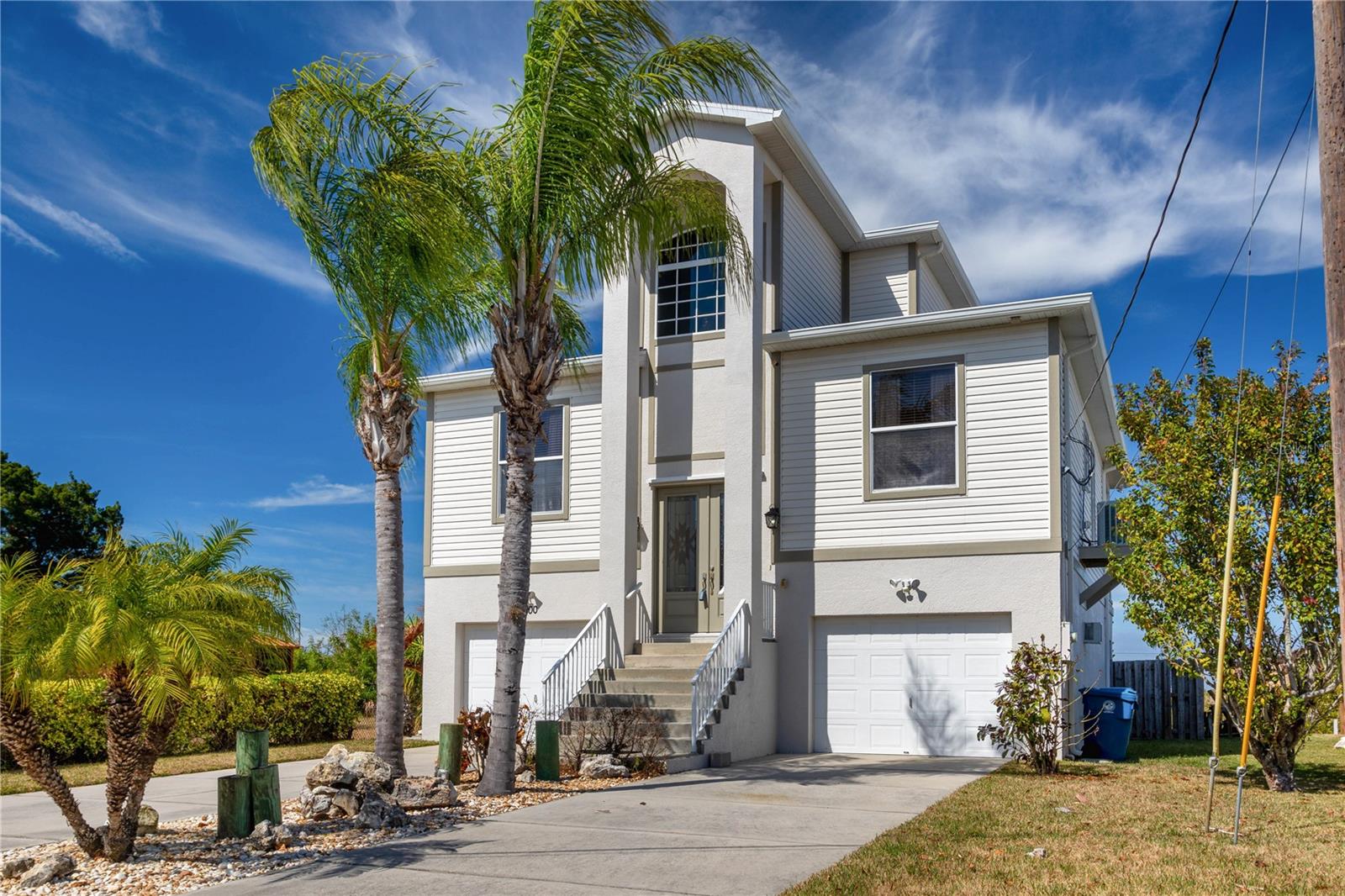 Beautiful Hernando Beach 3 Story Home With Great Views- 3 Bedrooms- 2 Full Bathrooms And A 3 Car Garage- Enter The Home From The Dual Door Entry To The Living Room With A Gas Fireplace- Eat In Kitchen With Granite Counter Tops, Newer Stainless Steel Appliances, Gas Stove And Dining Area- 2 Guest Bedrooms- Screened Porch With A Spiral Staircase To The Lower Level- The 3rd. Floor Has The Primary Bedroom With A Remodeled Bathroom Dual Shower Heads, French Doors To A Private Porch With Hurricane Shutters- Extras Include 2 AC Units, New Roof 2019, Outside Compressor 2017, Inside Laundry Room With Wall Cabinets, Interior Paneled Doors, Newer Screens On The Porches, Brick Paver Walkway To The Floating Dock, Impact Windows, Ceiling Fans, Fenced Yard, Break Away Walls In The Garage And A Large Storage Room- The Home Has A Generator Connection On The 2nd. Level- Interior An Exterior Repainted, Call Today For A Showing.