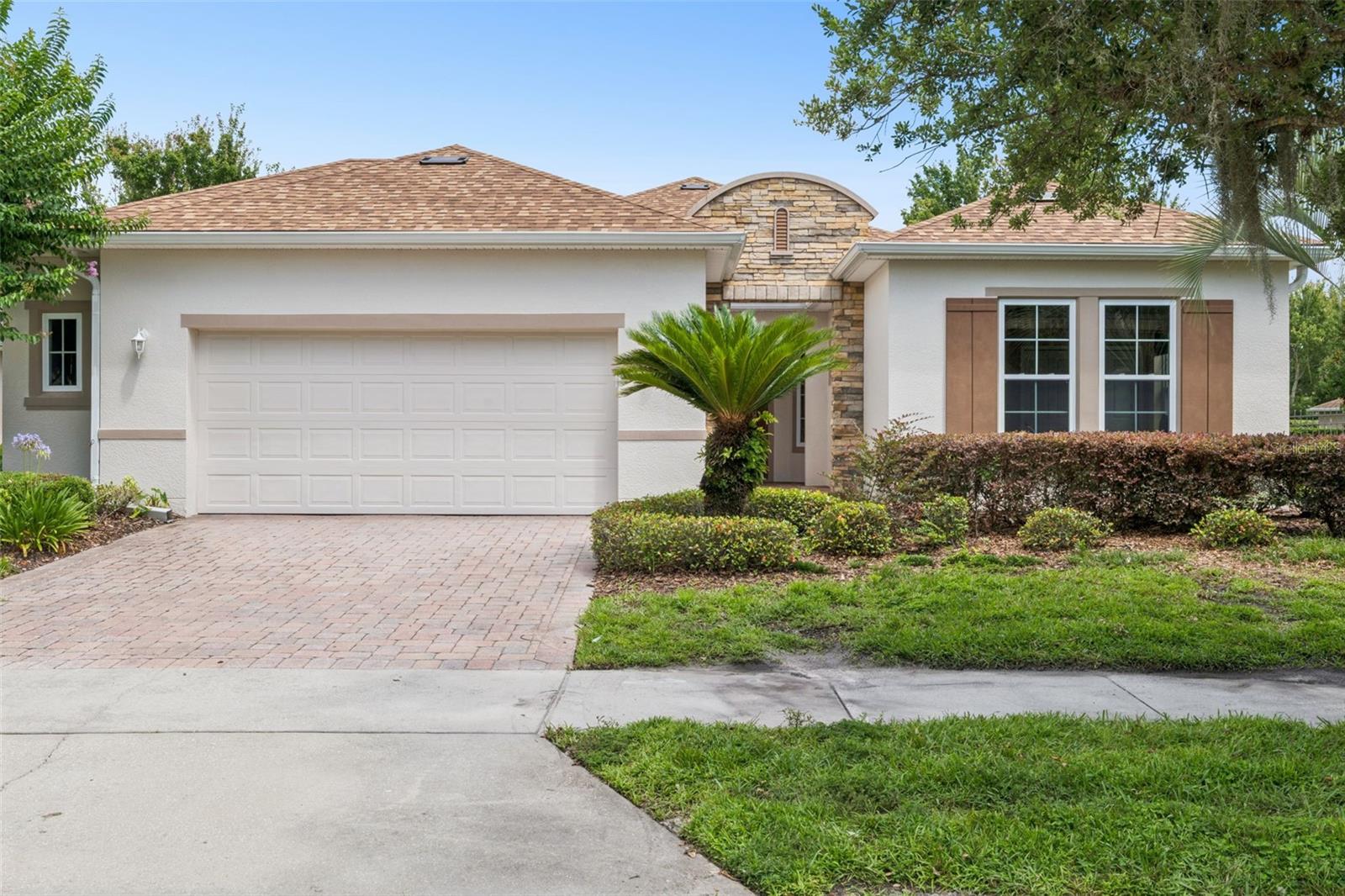 Under contract-accepting backup offers. Meticulously maintained SHEA “Shiraz” on a fenced pie-shaped homesite with a mature privacy hedge in the 55+ Victoria Gardens neighborhood. This floorplan provides 2 BD/2BA/Den plus a 14’ x 8’ "Smart Room" w/ built-in desk, storage cabinets that is ideal for a home office & built-in laundry tub. Recent updates are a New Roof 25’ & A/C system in 2022. Home features include leaded glass front entry door, 18” ceramic tile & luxury vinyl throughout main living areas, granite countertop in kitchen w/ large breakfast island, PULL-OUT SHELVING, RADIANT BARRIER in attic space for low electric bills, custom built entertainment wall unit in Great Room area, DOUBLE PANE windows & window shades throughout home. Kitchen offers 42” light Maple cabinets w/ crown molding, tile backsplash, pendant lighting above the breakfast bar, electric glass top range, Pot & Pan drawers, slide-out shelving, stainless steel appliances & a walk-in pantry. The 18’ x 14’ primary bedroom offers ceiling fan, 9’6” x 11’ walk-in closet, multiple windows for natural light, rolldown shades & drapes. En suite bathroom has a large frameless glass enclosed walk-in shower w/ bench seat & a granite countertop vanity with dual sinks. Den/office features double French door entry, ceiling fan, luxury vinyl flooring & Shangri-la blinds. You will enjoy relaxing in total privacy on your 25’ x 23’6” screen enclosed covered lanai with brick pavers & a ceiling fan. The 25’6” x 21’ OVERSIZED GARAGE gives you that extra space for your belongings or a work bench. ALL appliances stay with the home. Victoria Garden residents have access to their own Private Clubhouse. HOA fee includes lawn care, Spectrum HFC TV & internet and reclaimed water for yard irrigation. Community is within 1 mile of I-4 that offers great access to the east coast beaches, Orlando (40 minutes) and 3 International airports within 1 hour.