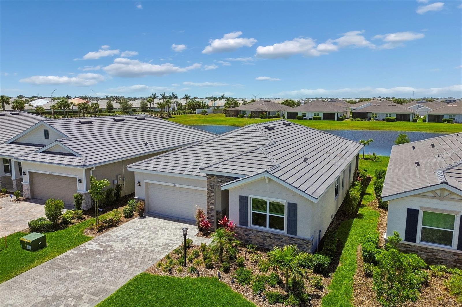 One or more photo(s) has been virtually staged. STOP SCROLLING | Curb Appeal | Tile Roof | Paver Driveway | Upgrades | Western Lakeview Exposure!!! Then there are places "You Choose" because something inside you is ready for a "New Life".  Welcome to Star Farms at Lakewood Ranch —a place where life is just BETTER!! The warm sunshine you feel sitting on your lanai with your first cup of coffee as the Florida sun comes up awaiting "Your New Life-style". The life that is "I'm done dreaming" "I'm finally moving to Florida" Everything you can imagine and only a short half hour drive to the Best Beaches in the world! The day filled with activities and all the way to the evening golf cart ride after dinner, the sound of neighbors becoming friends, the peaceful lake view beyond your backyard, and the feeling that you are finally living somewhere that gives something back to you. This is resort-ranch living with soul.  A community designed for connection, movement, wellness, and ease~ where you can spend the morning at the fitness center, meet friends by the pool, walk the trails, enjoy the dog park, play pickleball, or enjoy the restaurant..being outside and remember what it feels like to breathe. Star Farms was created for those who want more than a beautiful home. It was created for those who want a beautiful rhythm of life. The Country Beachy lifestyle...wait until you see the exclusive Adventure Retreat and have the experience you've been dreaming of —a setting that invites you to live actively, socially, and fully, while still coming home to peace. On the quiet street of Beach Ranch Terrace, the story becomes personal.  A nearly new 2024 Emerald series luxury home with over ($40,000 in upgrades), beautiful brick pavers and an elegant yet tough lasting real tile florida roof. The upgraded enhanced landscaping with Palm trees and lighting adding to the curb appeal. This one level living designed spacious with 3BR, 2BA split floor plan for privacy, plenty of closet space, and serene lake views, this home offers (Brand New Furniture Negotiable) the comfort and ease of simplicity moving to Florida. The open floor plan, stone counters, impressive kitchen island, walk-in pantry, smart-home features are some of the main features. The additional upgrades Accent wall, beadboard detailing on the island, and wainscoting with chair rail throughout the main living area. Adding the impressive lighting pendants hanging over the center island and also new upgraded lighting and fan fixtures throughout, creating light-filled spaces in every room-including epoxy garage flooring. The screened patio and water view invite you to slow down, exhale, and enjoy the life you worked so hard to create. This is the kind of home where you could wake up each morning with purpose. Where you could host the people you love. Where you could walk out the door and feel connected. Where you could finally stop waiting for vacation —because life itself starts to feel like one.  Star Farms is not just a community. It is a reminder that your next chapter can healthier, and more alive than the one before it...And maybe that is the real luxury...not just the home...not just the amenities...not just the Lakewood Ranch address. But the feeling of coming home to a beautiful sunset and a life that finally feels like yours. Call for a tour of this exclusive home in Adventure Retreat and learn about what Star Farms has to offer ~ you ~ Today!