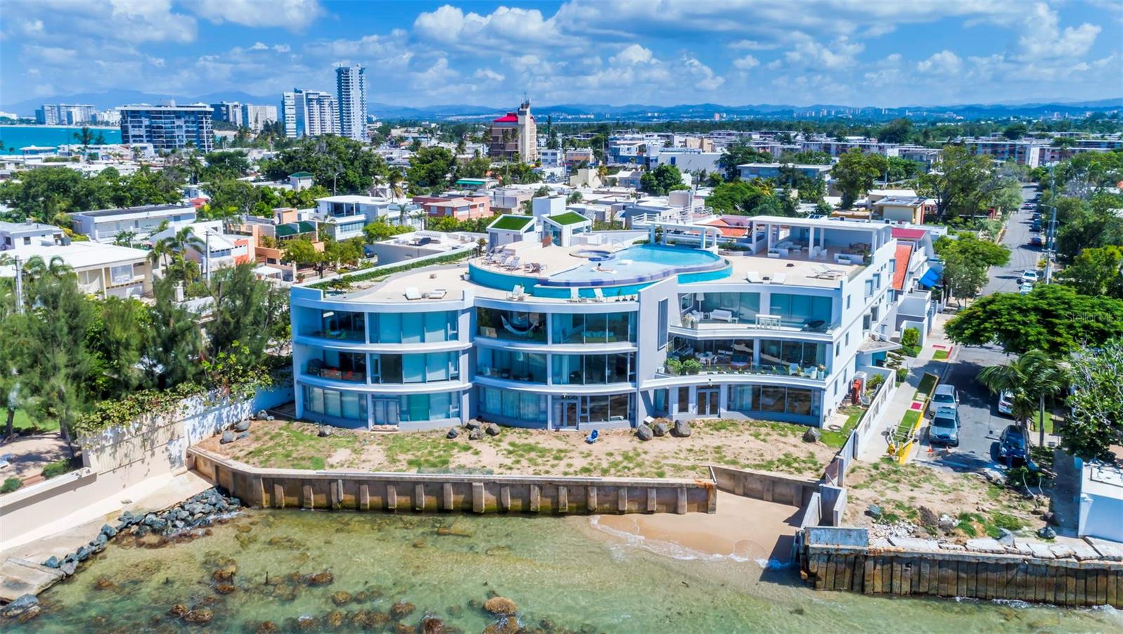 Understated luxury pervades the serenely elegant living environment, an inspired revelation of space, light, and form that balances grace and noblesse, boldness and restraint, rich complexity, and spare refinement. Welcome to Azure Beach at the gated Almendro Street in Punta Las Marias!

This spectacular oceanfront Penthouse conceived with contemporary architecture offering exceptional proportions and stunning views. The residence is exquisitely designed throughout 3,217 square feet, configured with three bedrooms each with a full bathroom, and a bonus room with a full bathroom, elegant marble floors throughout and a charming open terrace. The interior space exudes sophistication, combining comfort with style. The open floor plan seamlessly integrates the living, dining, and kitchen areas, creating a perfect environment for entertaining guests or enjoying quality family time. The fully equipped gourmet kitchen features sleek cabinetry and stainless-steel appliances.

Wake up to the gentle sound of waves and be mesmerized by the enchanting ocean vistas that stretch as far as the eye can see. The floor-to-ceiling windows and spacious terrace ensure that you will never miss the beauty of the surroundings.

Azure Beach is a resort-style development that would be impossible to duplicate today. Residents of Azure Beach enjoy the most impressive roof-top of any development in San Juan that includes an infinity pool and spacious open and covered terraces to entertain the most demanding guests. Seat and relax to witness dramatic sunrises and sunsets. The development offers a full power generator and water cistern.