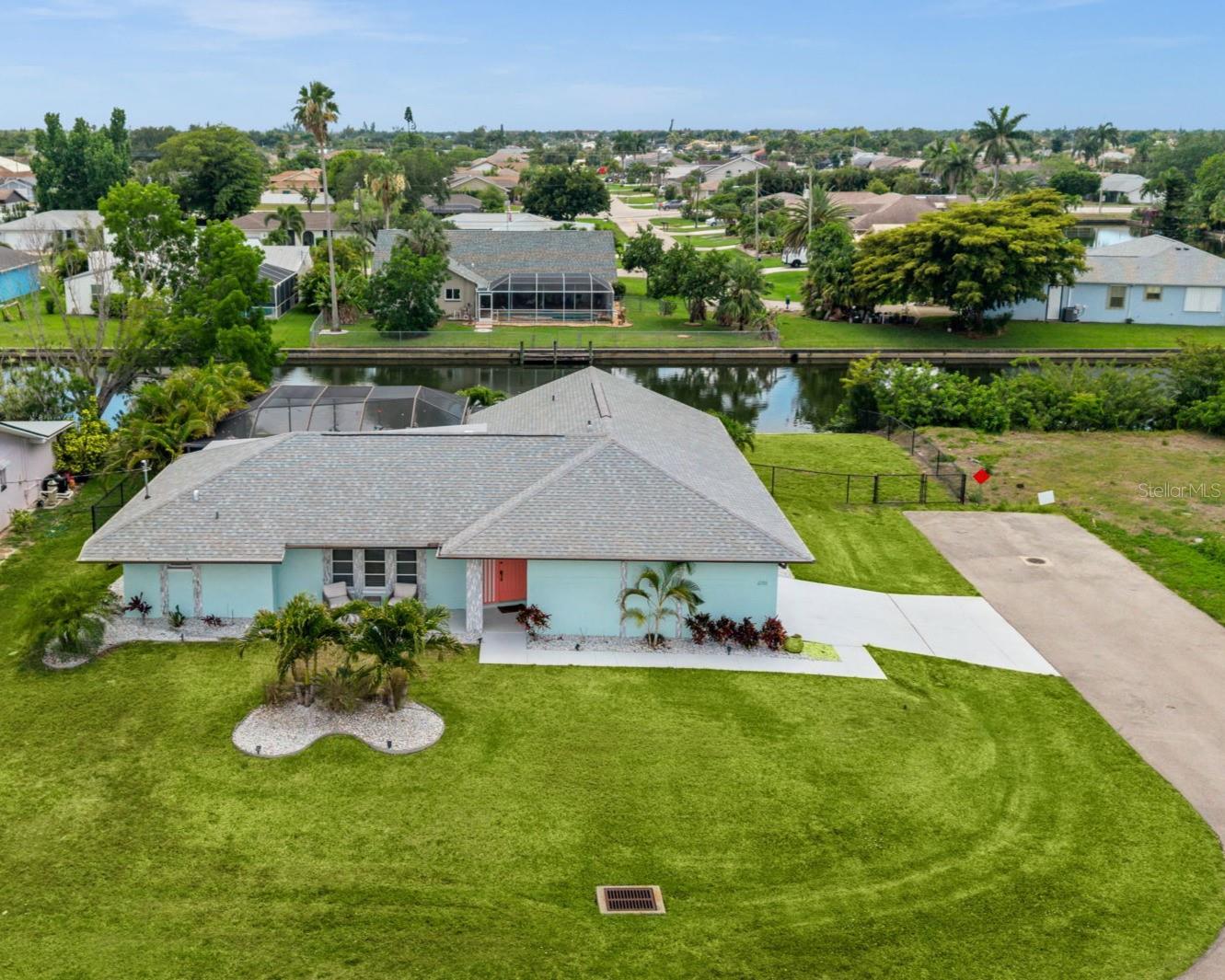 TURNKEY WATERFRONT POOL HOME WITH SOUTHERN EXPOSURE, OVERSIZED CORNER LOT, AND SUCCESSFUL SHORT TERM RENTAL HISTORY! Welcome to 2102 SE 8th St, a 3-bedroom, 2-bath Cape Coral home offering 1,613 sq ft of living space, 110 FEET OF FRESHWATER CANAL FRONTAGE feet, and a private setting at the END OF A DEAD-END STREET. This home is sold TURNKEY furnished and is already part of a STRONG SHORT-TERM RENTAL PROGRAM with over 80 five-star reviews, repeat guests, direct bookings, and room to expand exposure beyond Airbnb.

The OVERSIZED corner lot offers great privacy, with mature landscaping, tall hedges, and a peaceful canal backdrop just two doors from an intersecting canal basin. The SOUTHERN EXPOSURE backyard delivers all-day sun, while the large screened lanai, HEATED OVERSIZED POOL, and pocket sliders create an easy indoor-outdoor Florida lifestyle. Enjoy kayaking, fishing, relaxing by the water, or sitting on the dock for sunrises and sunsets.

Inside, the home features waterproof vinyl flooring throughout, updated lighting and paint, and a walk-through kitchen with Brazilian quartzite countertops, glass tile backsplash, stainless appliances, and soft-close wood cabinetry. All bedrooms include walk-in closets. The primary suite has been fully renovated with dual sinks, a tile and glass walk-in shower, and a walk-in closet. The guest bath also serves as a convenient pool bath.

Recent updates include a 2023 roof, 2022 garage door, 2022 electrical panel, new pool heater, refinished pool, new water heater, new water pump, new landscaping, and more. The backyard also includes mini golf, and the home is FULLY STOCKED with games, activities, kayaks, beach supplies, and family-friendly extras that ALL CONVEY. NO HOA, NOT IN A FLOOD ZONE, and close to restaurants, shopping, and Fort Myers. A rare opportunity for a furnished waterfront home with lifestyle appeal and PROVEN RENTAL DEMAND.