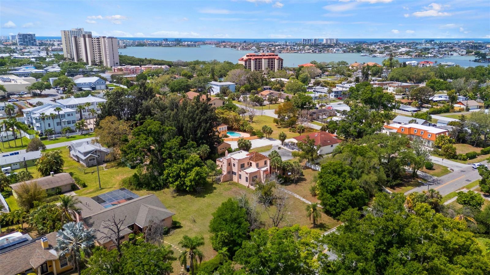 Excellent Opportunity in Pasadena: Three Lots with Alley Access.  Surveys are available, along with a letter from the City of St. Petersburg confirming three buildable lots, subject to County  Approval and Replat. The Park Street location offers convenient access to shopping, dining, local beaches, Gulfport and Downtown St. Petersburg.  This distinguished Mediterranean-style residence, constructed in 1925, retains numerous original features, including hardwood floors, beamed ceilings, stucco walls, and vintage glass doorknobs—a testament to its historic character. The property encompasses three lots, with the main house spanning two western lots and the third lot remaining undeveloped. Options include retaining the third lot for amenities such as a pool, cabana, or guest house, or selling it to finance restoration efforts. The home requires significant renovation, including a new roof, plaster repairs, plumbing and electrical upgrades, and kitchen and bathroom modernization. Prospective buyers should be prepared for extensive restoration.  The seller prefers to sell all three parcels together.  Survey and Elevation Certificate Available.