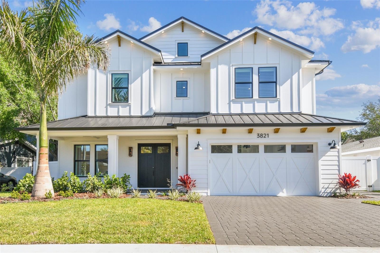 NEW CONSTRUCTION – Move-in ready modern farmhouse masterpiece. This 6-bedroom, 5.5-bath, 4,600-square-foot home sits on an oversized 67x120 lot within the highly sought-after Roosevelt, Coleman, and Plant school district. Designed and built beyond the building code, the home features an elevated foundation, standing seam metal roof, sealed building envelope with mechanical ventilation, all-Hardie exterior, and impact-rated, high-efficiency windows and doors. The 10-ft ceilings, 8-ft solid-core doors, spacious rooms (including four full suites), and Level 4+ smooth-finish drywall create a sense of grand luxury. Abundant windows and glass doors flood the open floor plan with natural light, highlighting wide-plank European white oak flooring throughout the home. The chef’s kitchen features an oversized island with seating for 6 to 8, Wolf and Subzero appliances, two gas ranges, an electric wall oven, microwave, dual dishwashers, a walk-in pantry and a wet bar with dual-zone wine cooler, beverage cooler, and RO-filtered water. The first floor also includes a spacious foyer, mudroom, powder room, flex room, two storage closets, gas fireplace with custom oak mantel and art frame TV, and a private guest suite with a walk-in closet and full bathroom with direct pool access. Outdoors, enjoy a fully automated saltwater pool and spa with heating and cooling, a large front porch, and a rear lanai with a complete outdoor kitchen. Upstairs, the primary suite features a tray ceiling, spa-style bath with soaking tub, double glass-enclosed shower with rain head and wand, dual vanities with makeup counter, two custom walk-in closets with built-in dressers, and a safe room. Three additional guest suites each include their own full bath and walk-in closet. A 14x20 media room with bar and beverage cooler, oversized laundry with dual washers and dryers, and an understairs storage room complete the second level. The home includes dual HVAC systems with UV purification and fresh air intake, an air-conditioned garage with Tesla charger, insulated door, and Wi-Fi opener with camera. Additional features include a whole-house water filtration and softening system, 400-amp electrical service, LED lighting throughout, over 120 light fixtures, under-cabinet and ambient lighting, and two tankless gas water heaters. A fully integrated smart home package includes hardwired security with touchscreen panels and motion sensors, Lutron Caseta, Hue lighting, Juke+ audio with five speaker zones, direct fiber internet, and Cat6 wiring to every room. A hardwired Eero system with three wireless access points ensures seamless, ultra-fast Wi-Fi coverage across the entire property. All closets have custom storage systems with extra shelving and all windows have premium plantation shutters installed. The exterior features upgraded landscaping with a variety of well thought out specimens, zoned irrigation, integrated landscape lighting, and underground electric for a clean streetscape. This brand-new residence by Suddath Homes Collection and Dorado Construction is completely move-in ready and includes a full 1-2-10 home warranty.