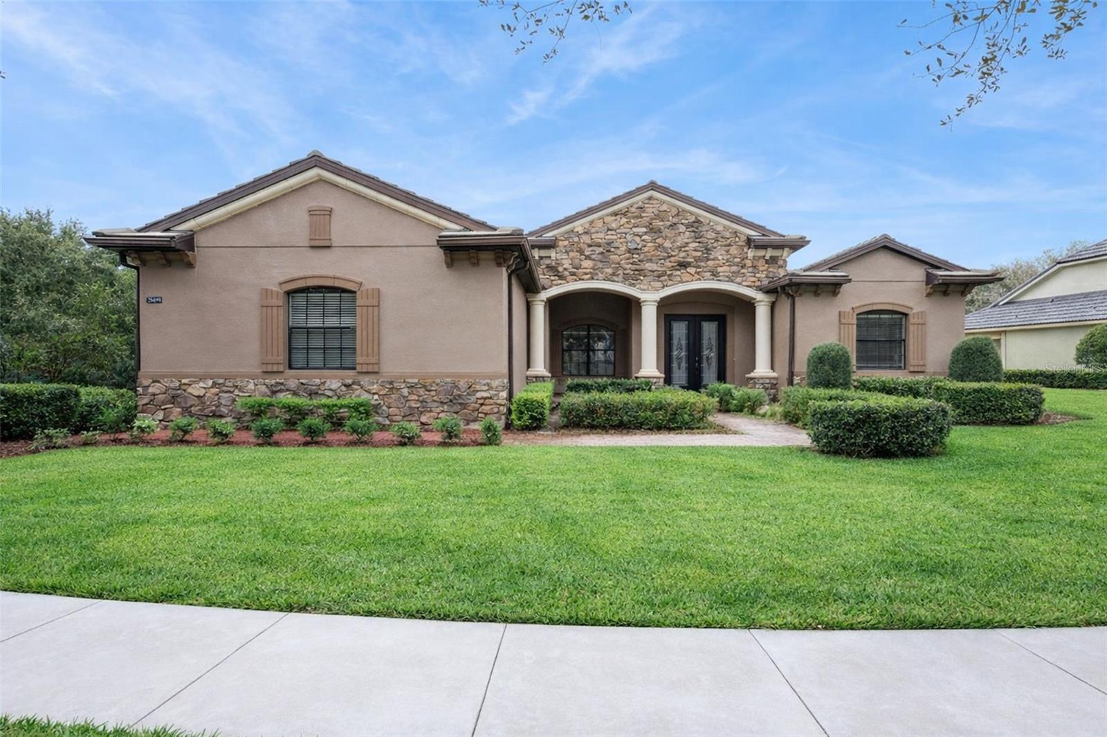Welcome to RedTail—Lake County’s sought-after, gated golf community—where luxury living meets a relaxed Florida lifestyle. This beautiful single-story home offers standout curb appeal with stone accents and an inviting covered entry, plus a premium golf-course setting with no rear neighbors for added privacy.

Inside, you’ll love the bright, open feel with soaring ceilings, elegant architectural details, and a layout designed for both everyday comfort and entertaining. The renovated kitchen shines with modern finishes and upgraded appliances, flowing seamlessly into the main living and dining spaces. Large sliders open to the screened lanai—perfect for morning coffee, evening breezes, and effortless indoor/outdoor living.

The primary suite is a true retreat, featuring a private hallway that leads to double closets and a spacious ensuite bath. Enjoy dual vanities, granite counters, and a spa-like soaking tub for the ultimate unwind. A second oversized “double primary” suite adds incredible flexibility, complete with two closets and its own full ensuite—ideal for multigenerational living or long-term guests. Additional bedrooms are generously sized, and the guest bath is finished with granite counters for a polished touch. A dedicated laundry room (washer and dryer available if desired) offers convenient access to the garage.

Beyond the home, RedTail delivers resort-style amenities: a stunning clubhouse with on-site dining, a sparkling pool, fitness facilities, tennis courts, and scenic views throughout the community—plus an exceptional golf experience right at your doorstep.

Location seals the deal: enjoy easy access to charming downtown Mount Dora, with Publix just 5 miles away. You’re also minutes from the new 429 connection for a smooth drive to Orlando International Airport and the Disney theme parks—making daily errands, weekends out, and travel refreshingly convenient.