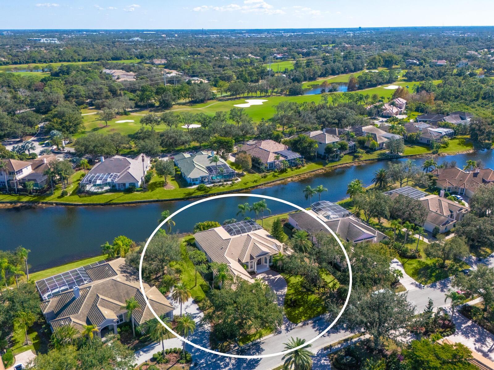 A NEW ROOF is Coming Soon!!  Should be completed by mid to late June!  Welcome to this beautifully appointed Neal Custom Homes residence offering serene water views, exceptional architectural detail, and resort-style outdoor living.  This 3-bedroom, 3-bath home with an oversized 3-car garage offers 3356 sf and is thoughtfully designed for both everyday comfort and elegant entertaining.
A double designer leaded-glass front door opens to a striking foyer with marble inlay flooring, setting the tone for the refined interiors. High-end ceramic tile laid on the diagonal flows throughout the main living areas, complemented by tray and coffered ceiling details, crown molding, custom niches, and recessed lighting. The living room features a triple tray ceiling, an electric fireplace, and pocket sliders that open seamlessly to the lanai.
The brand-new kitchen (2021) is the heart of the home, showcasing rich off-white wood cabinetry, exotic granite countertops, a quartz-topped center island, GE stainless steel appliances, subway tile backsplash, under-cabinet lighting, a spacious pantry, built-in oven with microwave, and an aquarium window in the breakfast area. Open to the family room and lanai, this space is ideal for entertaining.
The primary suite is a private retreat featuring a sitting area with bay-style windows, coffered ceiling, dual customized closets, double-door entry, and private access to the lanai. The spa-inspired, wheelchair-accessible primary bath offers an oversized marble-detailed shower, Jacuzzi tub, marble flooring, expansive double vanity with makeup area, cultured marble countertops, triple mirrors, and new designer hardware.
Bedroom two is a generously sized custom suite with a large closet and bath featuring a cultured marble vanity and tub/shower combination. Bedroom three is adjacent to a full hall bath with enclosed shower, linen closet, and updated brushed-silver fixtures. A large rear den with cathedral-style ceiling and sliders to the lanai can easily serve as a fourth bedroom with the addition of a closet.
Step outside to your private oasis with a kidney-shaped heated pool and spa, lush updated landscaping with lighting, and a covered lanai offering space for a future outdoor kitchen (currently equipped with refrigerator and cabinetry).
The oversized 3-car garage features higher ceilings, a painted floor, storage cabinetry, exterior access, and an electric hydraulic car lift, perfect for car enthusiasts. Additional highlights include central vacuum, exquisite lighting, select new fans, window treatments, brushed-silver hardware throughout, and a well-appointed laundry room with cabinetry, sink, and built-in ironing board.
Available furnishings may be purchased separately.