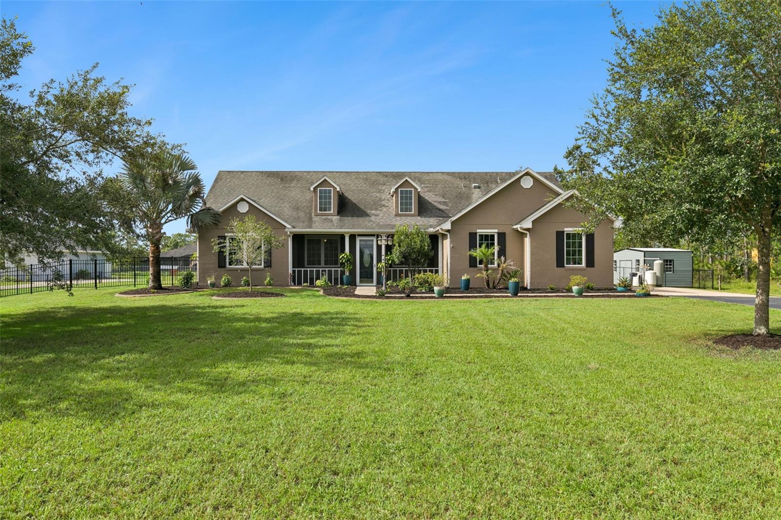 Discover the perfect balance of privacy, space, and modern updates in this beautifully maintained home on over an acre in Wedgefield! Nestled on a beautifully landscaped 1-acre homesite, this single-story home offers 3 bedrooms, 2 bathrooms, a dedicated office, and 1,905 square feet of thoughtfully designed living space. With no required HOA, you'll enjoy the freedom to embrace the acreage lifestyle while remaining conveniently close to everything Central Florida has to offer. Step inside to an inviting open floor plan featuring tile and laminate flooring throughout - no carpet! The spacious living room opens to the kitchen, creating an inviting gathering space, while the separate dining room offers added flexibility for entertaining and family dinners. In the kitchen you'll find stainless steel appliances, granite countertops, dinette space overlooking the backyard, and all appliances - including the washer and dryer - are included. The split-bedroom layout provides added privacy, while the primary suite features a walk-in closet, dual vanities, and a brand-new walk-in shower with a frameless glass enclosure (installed Feb 2026). Designed with both comfort and efficiency in mind, this home has been updated with a new roof (2018), HVAC system (2020), energy-efficient Pella double-pane Low-E windows (2020), and a hybrid water heater. Additional upgrades include an electric vehicle charger, hookups for a whole-house generator, ceiling fans throughout, an inside laundry room, and a two-car garage. Outdoor living is just as impressive. Relax on the screened front porch or unwind on the screened rear patio while overlooking the expansive fenced backyard. The one-acre lot provides endless possibilities, whether you envision future additions like a pool, other outdoor amenities or simply enjoying the privacy and room to roam. A storage shed adds even more convenience. Located in the sought-after, golf cart-friendly community of Wedgefield, you'll be just a short walk from Hal Scott Preserve, where miles of scenic trails await for hiking, horseback riding, bicycling, and fishing. Enjoy the serenity of country-style living while remaining just minutes from Lake Nona, Orlando International Airport, major highways, shopping, dining, Florida's Space Coast, world-famous attractions, and top-rated schools. If you've been searching for a home that offers room to spread out, thoughtful modern upgrades, and an unbeatable location, this exceptional property is ready to welcome you home.