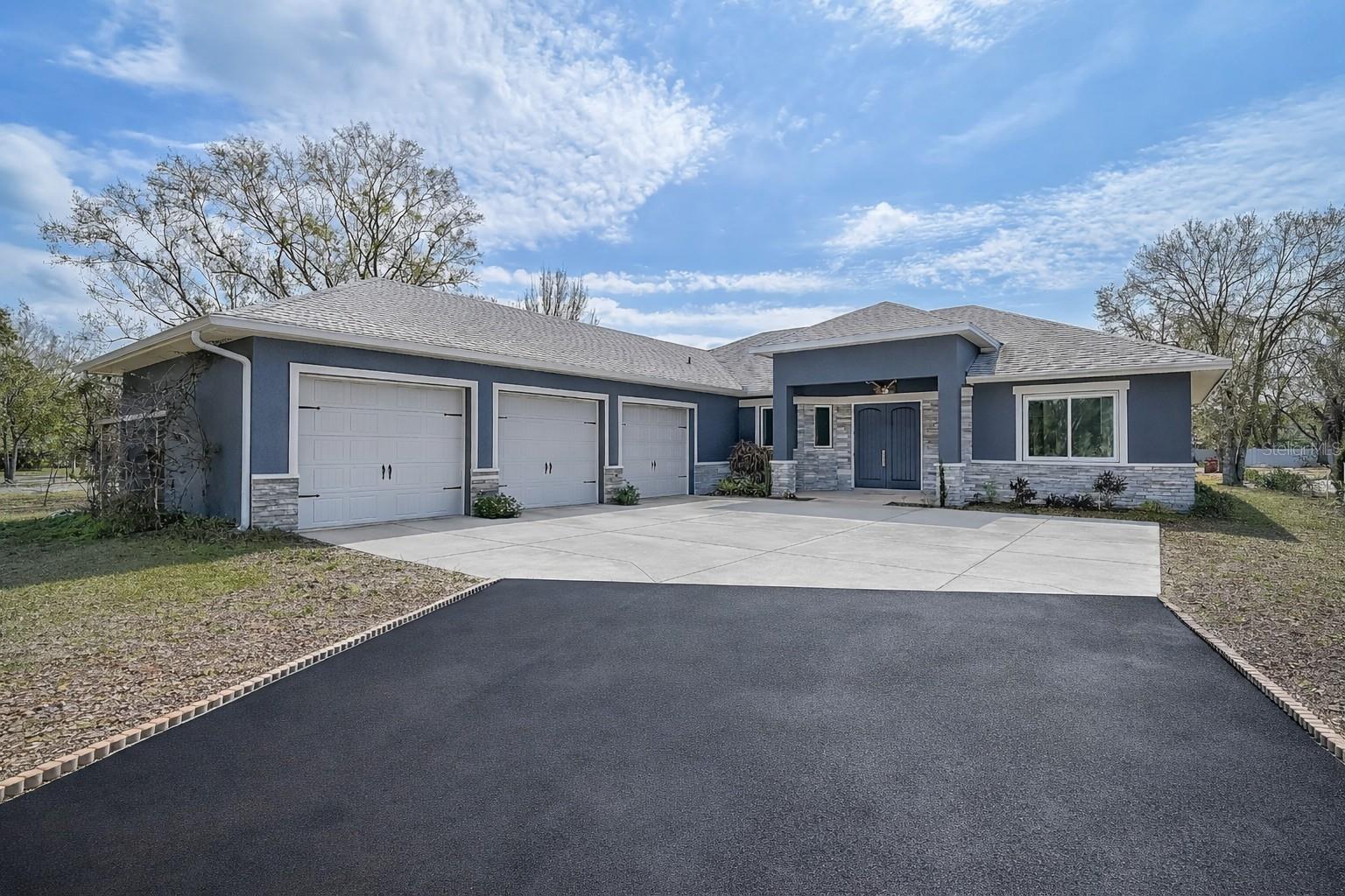 One or more photo(s) has been virtually staged. Exceptional value on nearly 2 Acres!  This custom home, only five years young, is perfectly positioned on nearly two private acres with no community deed restrictions — a rare and highly desirable feature for today’s buyers who value freedom and flexibility. Designed thoughtfully by the owner, every detail reflects quality craftsmanship, functionality, and intentional design.

A long blacktopped driveway provides a smooth and welcoming approach, leading to an impressive oversized three-car garage with ample space for vehicles, storage, or hobbies. The property is equipped with a whole-house water treatment system, adding comfort and peace of mind.

Inside, the open great room plan offers both spaciousness and versatility. There is plenty of room for entertaining, with a designated space that currently hosts a pool table (negotiable) and a wet bar that enhances the home’s entertainment appeal. The great room is beautifully appointed with a beamed tray ceiling featuring a rich wood inset design that adds warmth and architectural character.

The kitchen is a true focal point, outfitted with top-of-the-line stainless steel appliances, including a built-in wall convection oven, microwave, cooktop, and a sleek designer vent hood. A generous island with bar seating flows seamlessly into the family dining area, creating an ideal setting for gatherings both large and small. In addition, there is a private office/den, offering flexibility for remote work or quiet retreat.

Outdoor living is equally inviting. A screened-in back patio provides a comfortable space to relax year-round, while an additional open patio features a charming firepit — perfect for evenings under the stars. The rear portion of the property includes a 14x16 metal shed, offering convenient storage for equipment, tools, or recreational items you prefer not to house in the garage.  

Bring your RV, Trailers, horses, goats or chickens and enjoy the freedom of starting or moving your hobby farm to this piece of paradise!

This is a rare opportunity to own a nearly new custom home on acreage without restrictive HOA rules — offering space, privacy, and the freedom to truly make it your own.