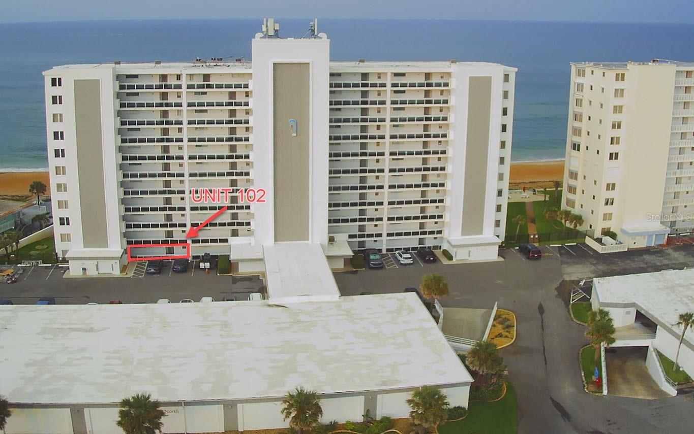 Rare ground floor unit with direct access to the beach and pool from your back patio. The first floor units in this complex offer a unique opportunity for owners who prefer not to deal with elevators or common spaces. Simply park and walk in the front door and exit through the back door down your private steps onto the sprawling lawn where the newly renovated pool sits slightly to the south ensuring privacy from your elevated oceanfront lanai. Surfside Club North is a solidly built complex sought after by locals, with a history of consistent maintenance and reasonable management that allows one-month rentals (with a strong demand). This unit has had tasteful updates that complement the coastal atmosphere, including wide plank LVT flooring, custom cabinetry and stone countertops.
The kitchen was opened up over a breakfast bar to become one with the oceanfront living room allowing for plenty of natural light and wonderful views of The Atlantic. The primary bedroom features a wall of glass that brings horizon views inside and a sliding glass door that opens directly onto the patio for an early morning walk on the beach. A generous closet and a private bath with a new vanity are dedicated to the master suite. The secondary bedroom also features privacy and ample closet space with a common bath just outside the door. While there is typically plenty of parking right in front of the unit, an assigned space is included in the enclosed parking garage. The building shows in immaculate condition and has completed its Milestone Study giving it a "clean bill of health" along with respectable financials, making it an ideal investment. The grounds here are stunning and the complex was designed to embrace the serenity of the natural landscape with native palms dotting the sprawling green oceanfront lawn. Look at all others and save this ground floor unit for the very last, as there is nothing quite like it.