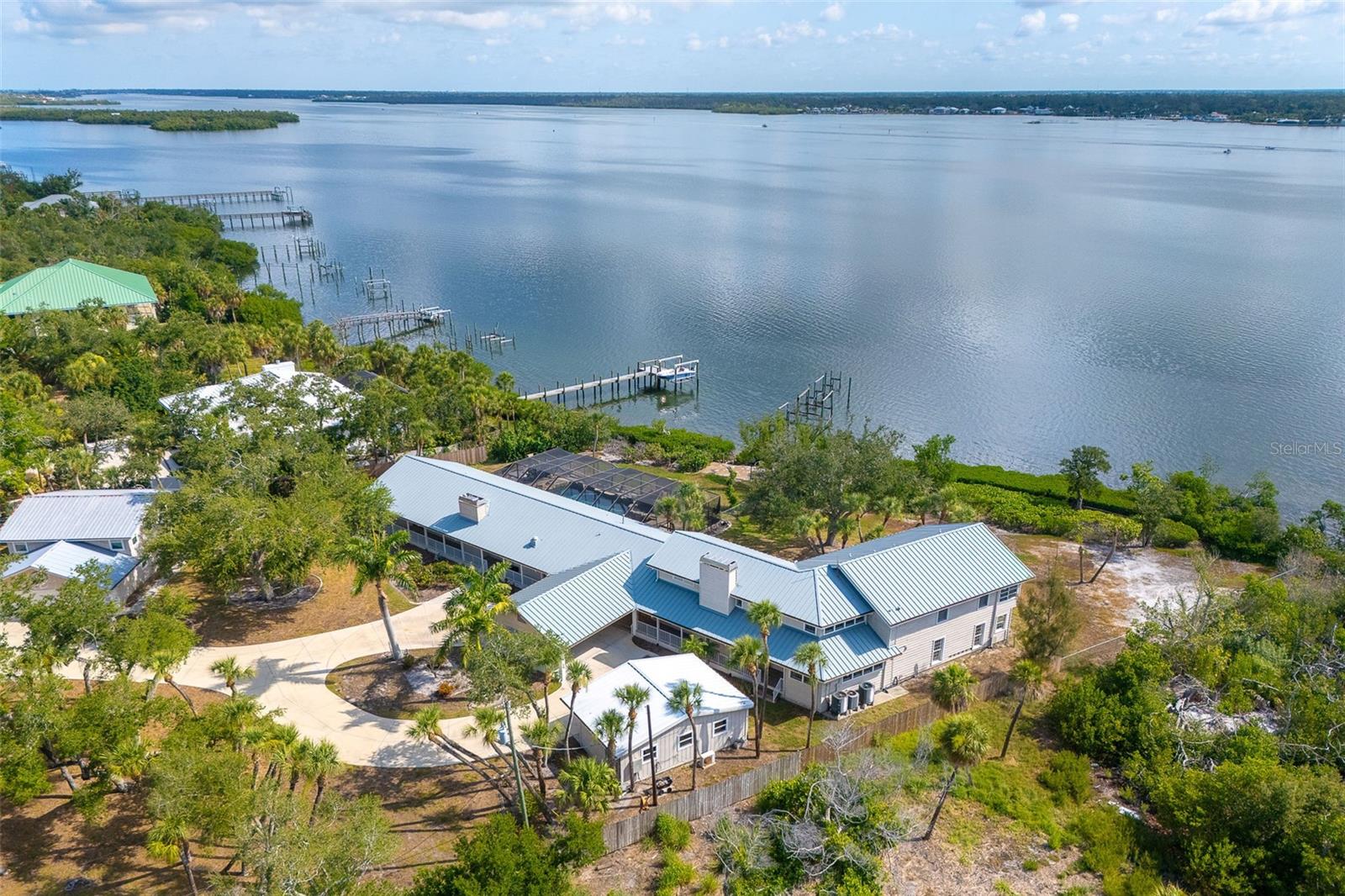 Virtually Staged. A rare Manasota Key opportunity, this private bayfront estate compound with deeded beach access offers the space, setting, and flexibility that make barrier-island living so special. Set on approximately 1.32 acres along Lemon Bay, the property includes multiple living structures with nearly 7,000 sq. ft. of combined living area by public record, creating exceptional options for family, guests, entertaining, work-from-home space, or a long-term legacy retreat.
The grounds are designed for relaxed waterfront living, with a pool and spa, expansive outdoor areas, and a dock on the Intracoastal/Lemon Bay side. The setting captures the best of Manasota Key: boating, water views, quiet residential character, and convenient proximity to Gulf beaches, Englewood, Venice, and Sarasota amenities.
The main residence and guest residence provide scale and versatility rarely found in this location. Buyers may choose to enjoy the property as a private coastal compound, update and personalize the existing structures, or explore future renovation possibilities consistent with Sarasota County requirements. With land, waterfront, privacy, and guest flexibility, this is not simply a house — it is a significant Manasota Key property with a story and uncommon potential.