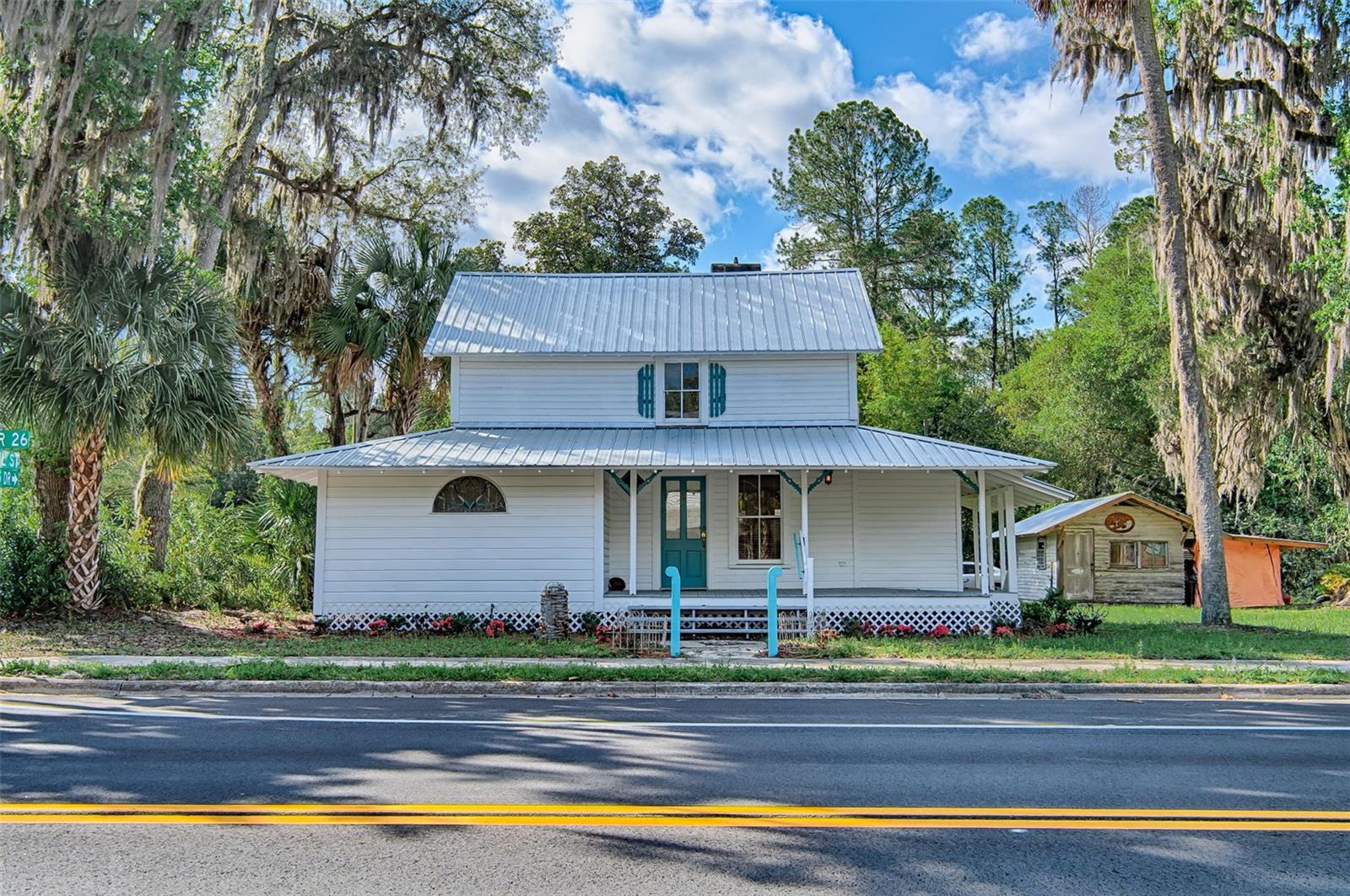 Step back in time while enjoying modern possibilities with this beautifully preserved historic home, originally built in 1885 by Henry Baldwin of Naugatuck, Connecticut. Nestled in the heart of picturesque Melrose, Florida, this two-story residence offers a rare blend of heritage, charm, and versatility.Featuring 4  bedrooms and 2.5 bathrooms, the home boasts classic architectural details and inviting living spaces filled with warmth and character. Relax and unwind on the  front or back porches, perfect for enjoying Florida’s tranquil surroundings, morning coffee, or evening gatherings.The property also includes a quaint metal-roofed workshop, brimming with potential—easily convertible into a charming guest cottage, studio, or creative retreat. There is also another small out building perfect for storage.Adding to its appeal, the property is zoned for home-based business use, offering a unique opportunity. Operate your business right from home, with the convenience of on-site work permitted as long as the owner resides on the property. Melrose is a small town with lots of charm. Boasting only one traffic light but twice as many art galleries and several lakes available for swimming, boating and other water activities. Melrose is also located 20 minutes from the city of Gainesville, home of the University of Florida and all that comes with a college town. Whether you're seeking a distinctive residence, a live/work opportunity, or a piece of Florida history, this property offers endless possibilities. Seller is open to owner financing.