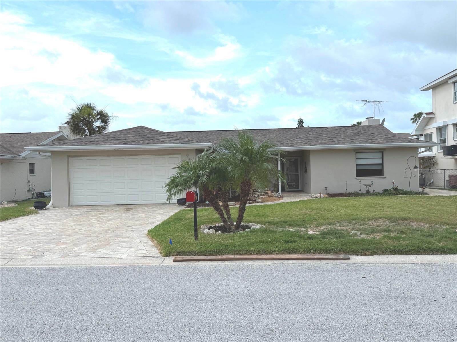 Fantastic opportunity awaits in this meticulously renovated waterfront home with an incredible 70 feet of waterfront.  The 3 empty lots across the canal from your home make the views even more incredible. This very desirable split ranch 3 bedroom, 2 bath open floor plan home is situated on a deep-water canal with access to the Gulf. A beautiful water feature at the front entrance will welcome you and your guests home in spectacular fashion. The home features plank style ceramic tile flooring throughout the spacious and open floorplan. The home features custom roll down shades throughout with the middle shade in the livingroom being a power shade. Driveway and walkways are all done in pavers. Garage floor, patio floor and sea wall have all been covered with epoxy coating. Spend a relaxing afternoon or watch the sunset from your home’s incredible outdoor entertaining space featuring a floating dock and the largest fixed dock in the neighborhood.  Outdoor amenities include two 10,000lb boat lifts, jet ski dock and a dock completely outfitted for fishing and cooking. More than enough room to bring all your water toys. Multiple sliding doors allow for easy access to the outdoor entertaining space and provide beautiful views of the canal. Access, is direct and moments away from the deep water of the Gulf of Mexico.
